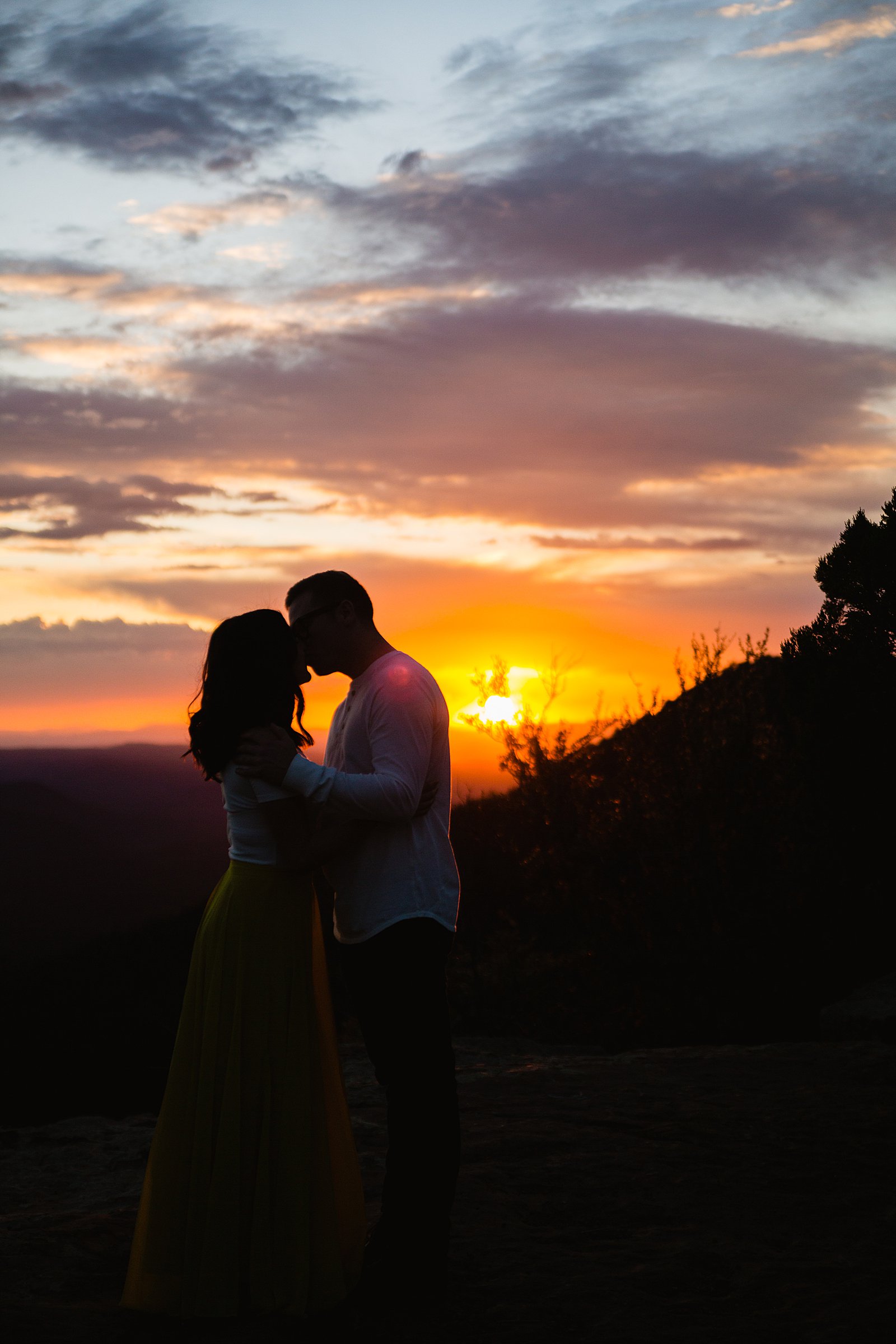Silhouette of a couple kissing at sunset during their Payson engagement session by Arizona wedding photographer PMA Photography.