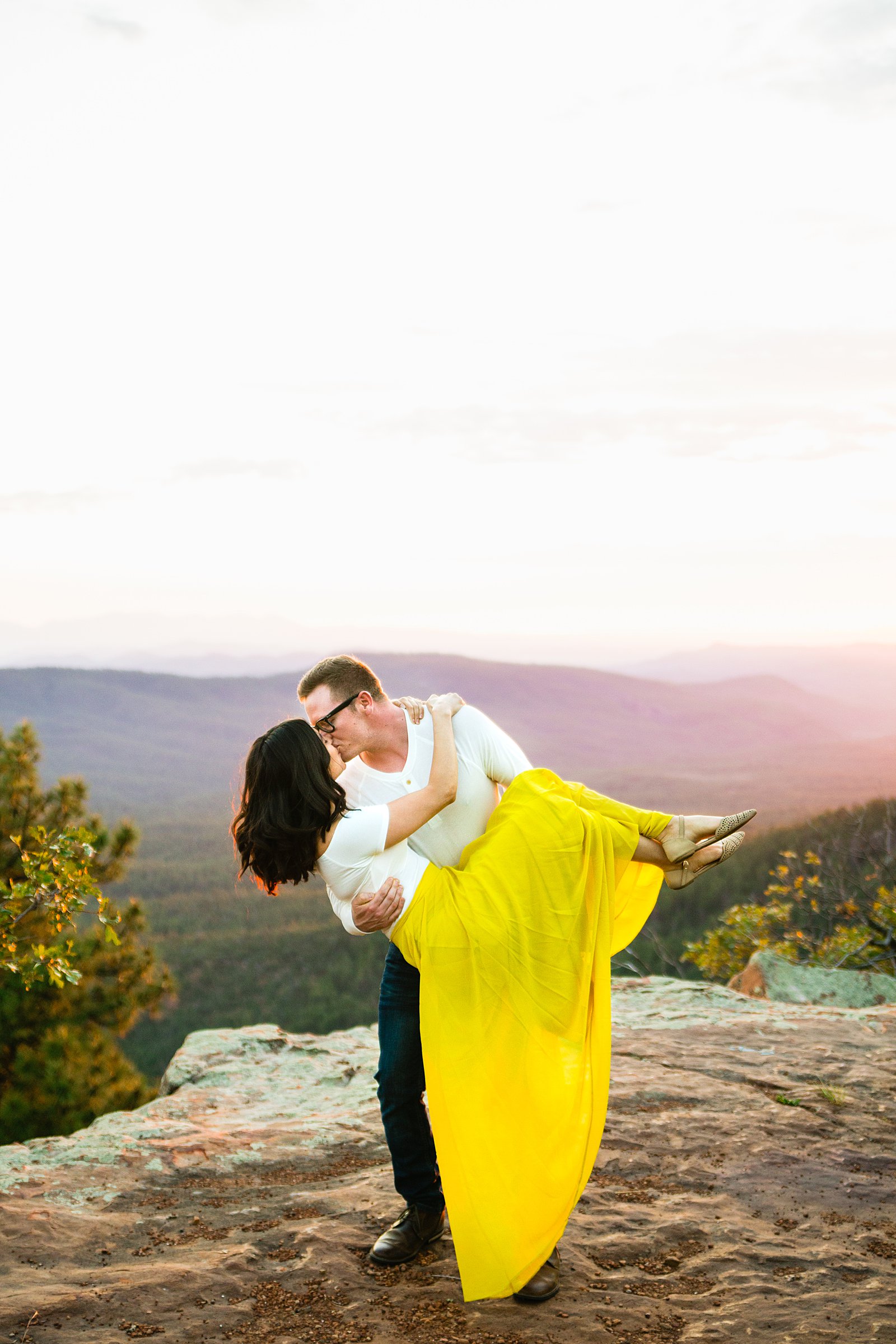 Couple share a romantic kiss during their Mogollon Rim engagement session by Payson wedding photographer PMA Photography.