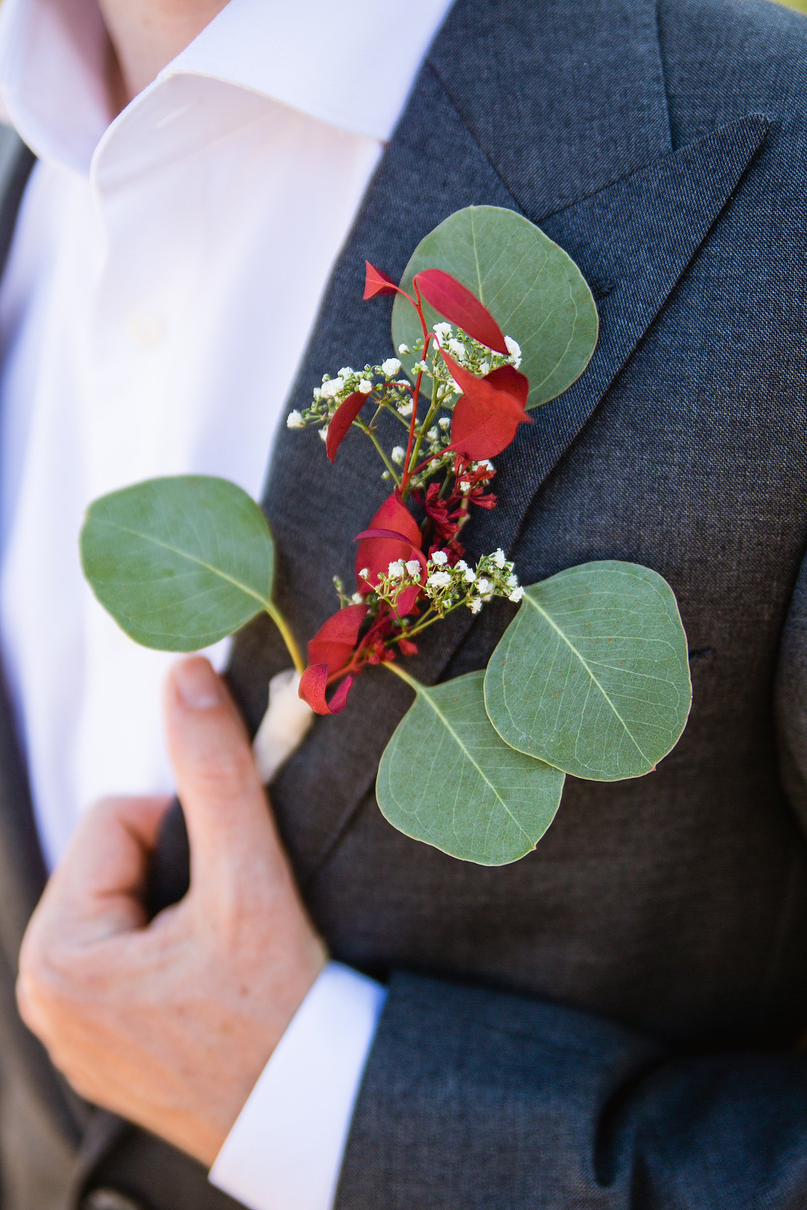 Groom's simple eucalyptus boutonniere by PMA Photography.