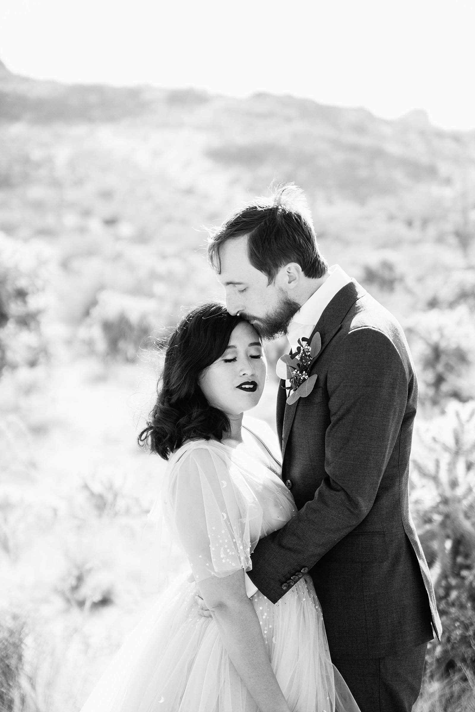 Bride and Groom share a kiss during their Cloth and Flame Superstition Mountain wedding by Arizona wedding photographer PMA Photography.
