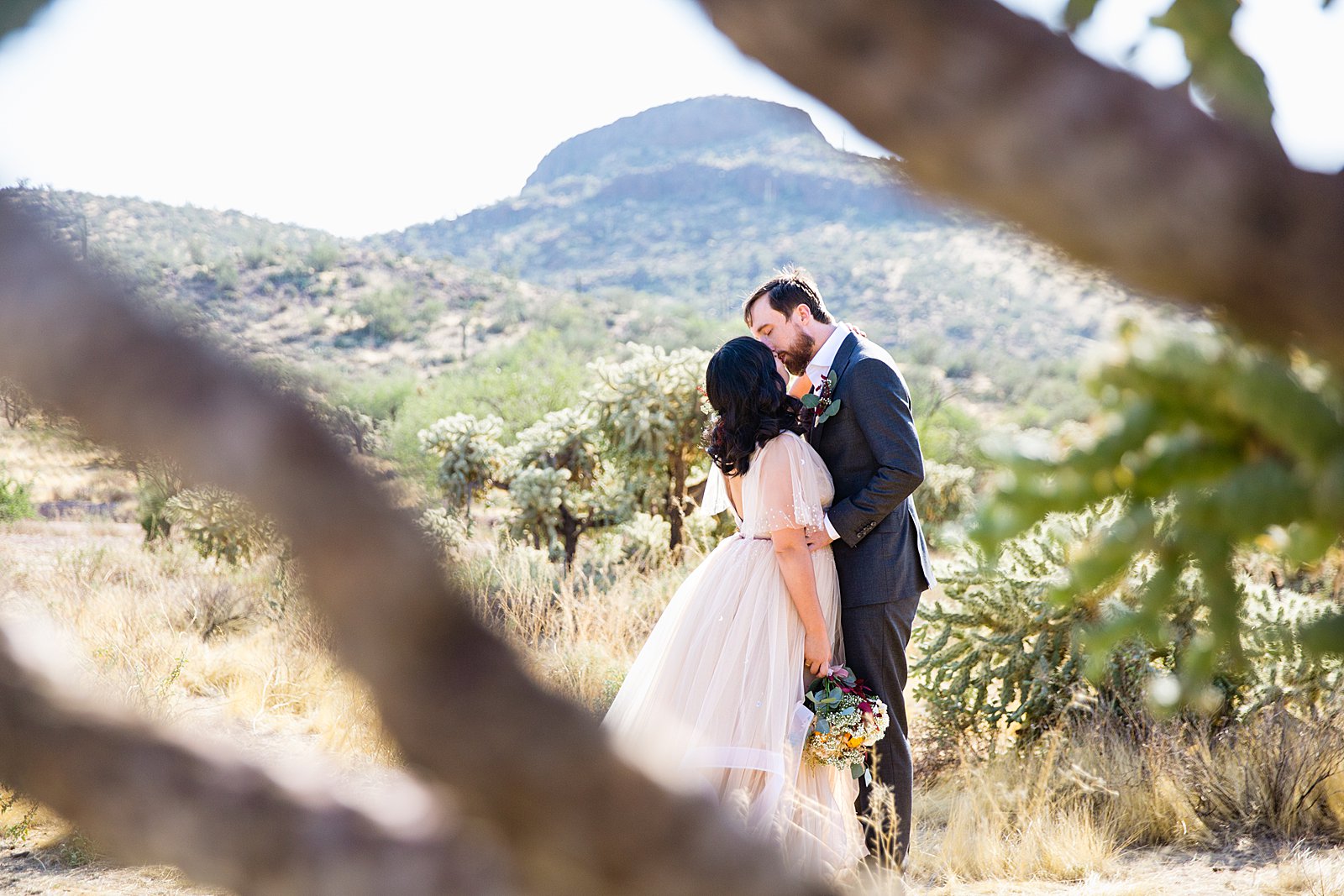 Bride and Groom share a kiss during their Cloth and Flame Superstition Mountain wedding by Arizona wedding photographer PMA Photography.