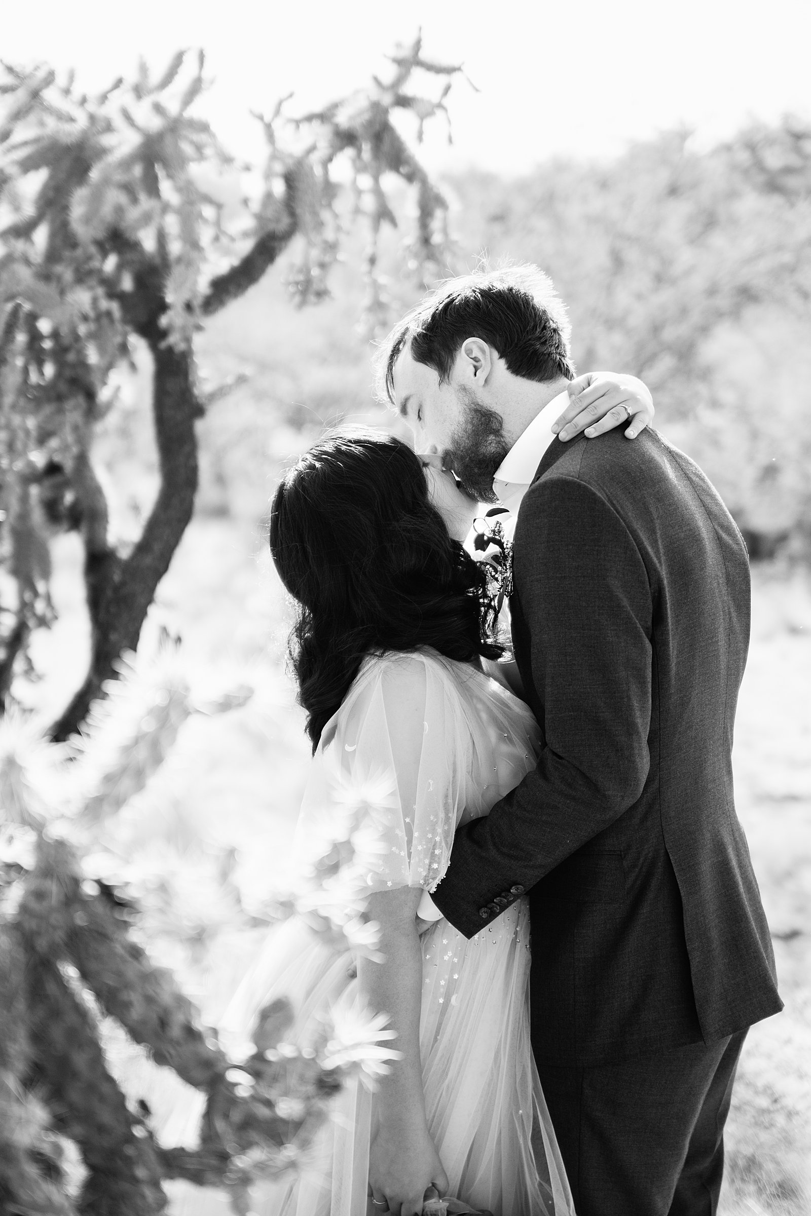 Bride and Groom share a kiss during their Cloth and Flame Superstition Mountain wedding by Mesa wedding photographer PMA Photography.
