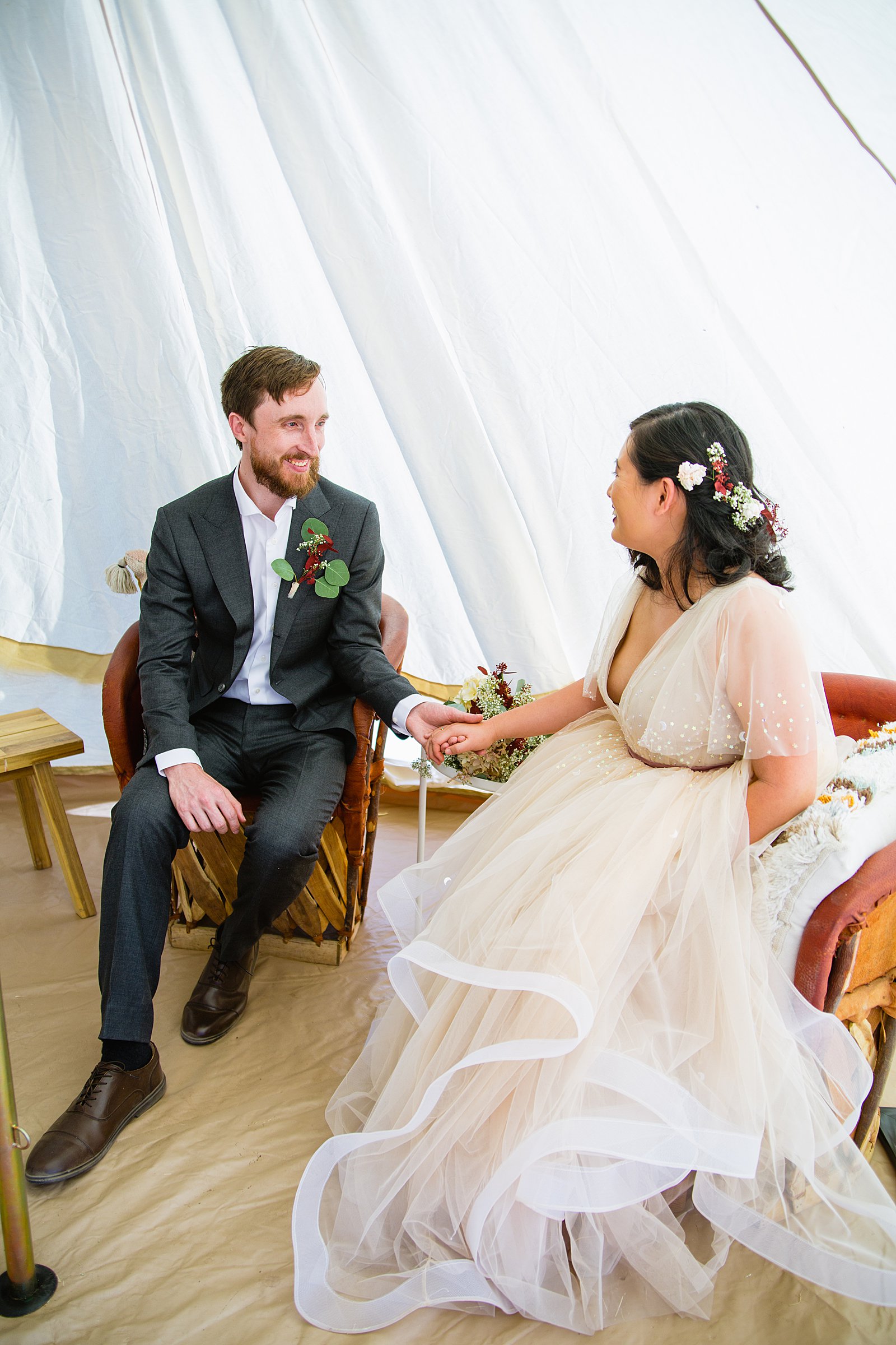 Bride and Groom hanging out in a yurt during their Cloth and Flame Superstition Mountain wedding by Mesa wedding photographer PMA Photography.