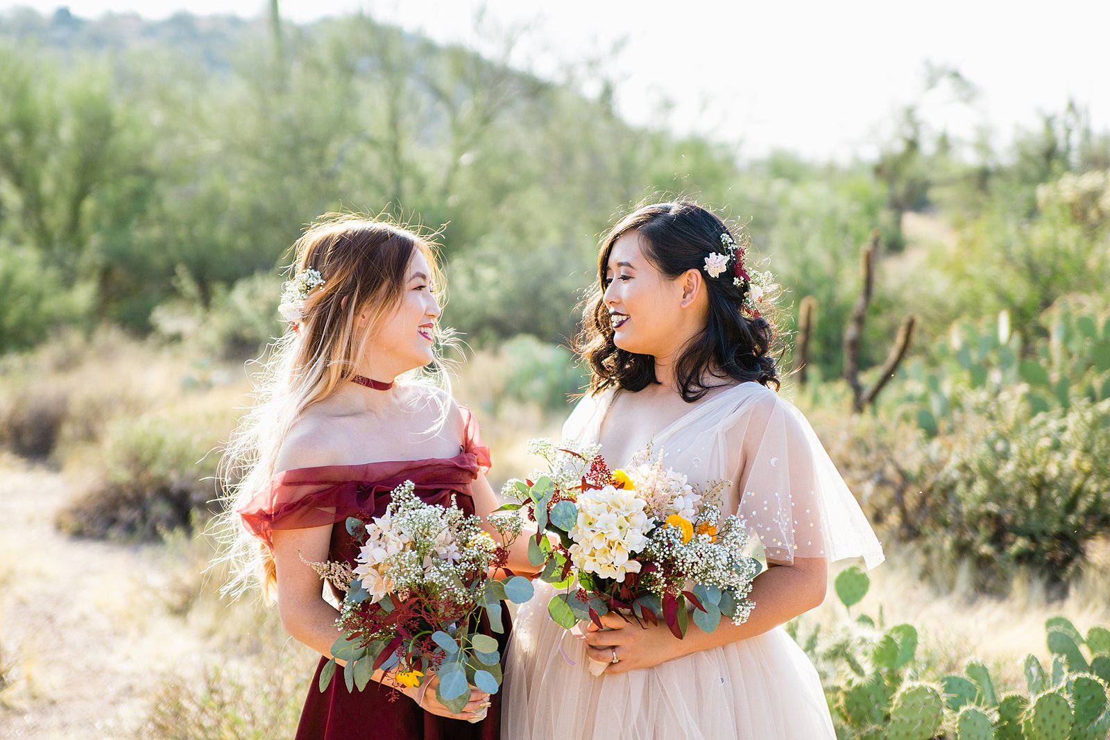 Bride and bridesmaid together at a Cloth and Flame Superstition Mountain wedding by Arizona wedding photographer PMA Photography.