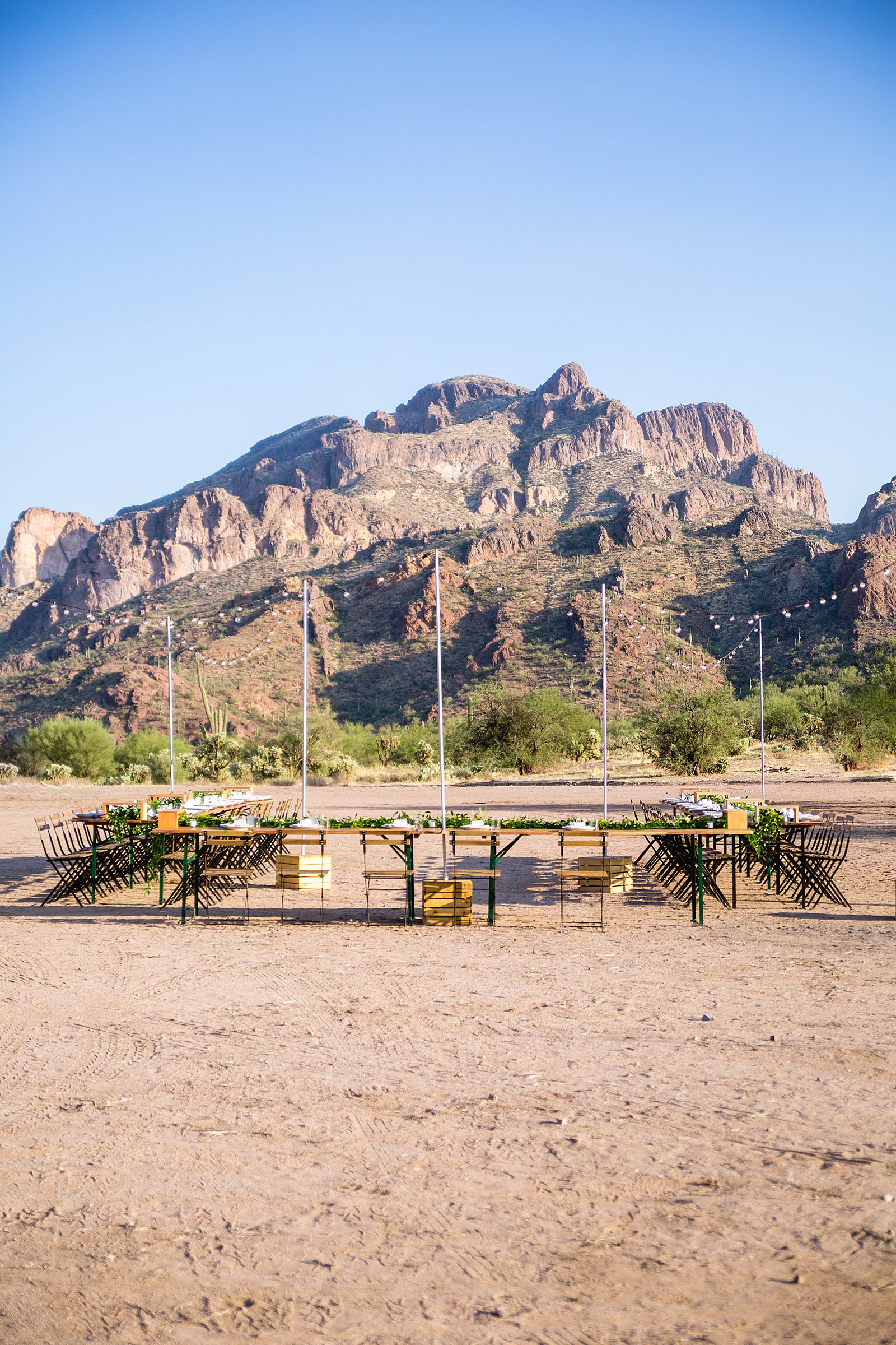 Rustic outdoor wedding reception at a Cloth and Flame wedding in the Superstition Mountains by Phoenix wedding photographer PMA Photography.