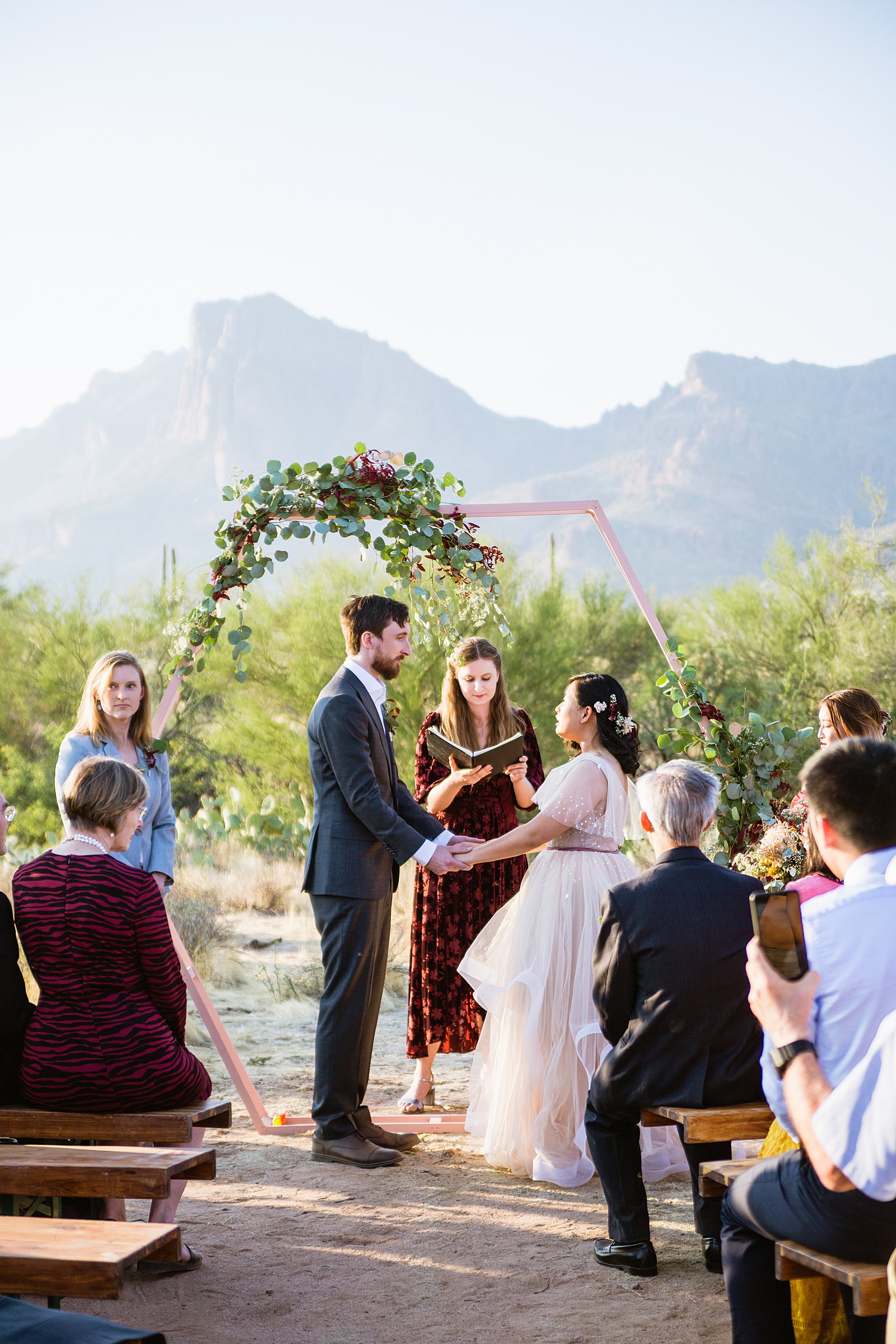 Wedding ceremony at a Cloth and Flame wedding in the Superstition Mountains by Phoenix wedding photographer PMA Photography.