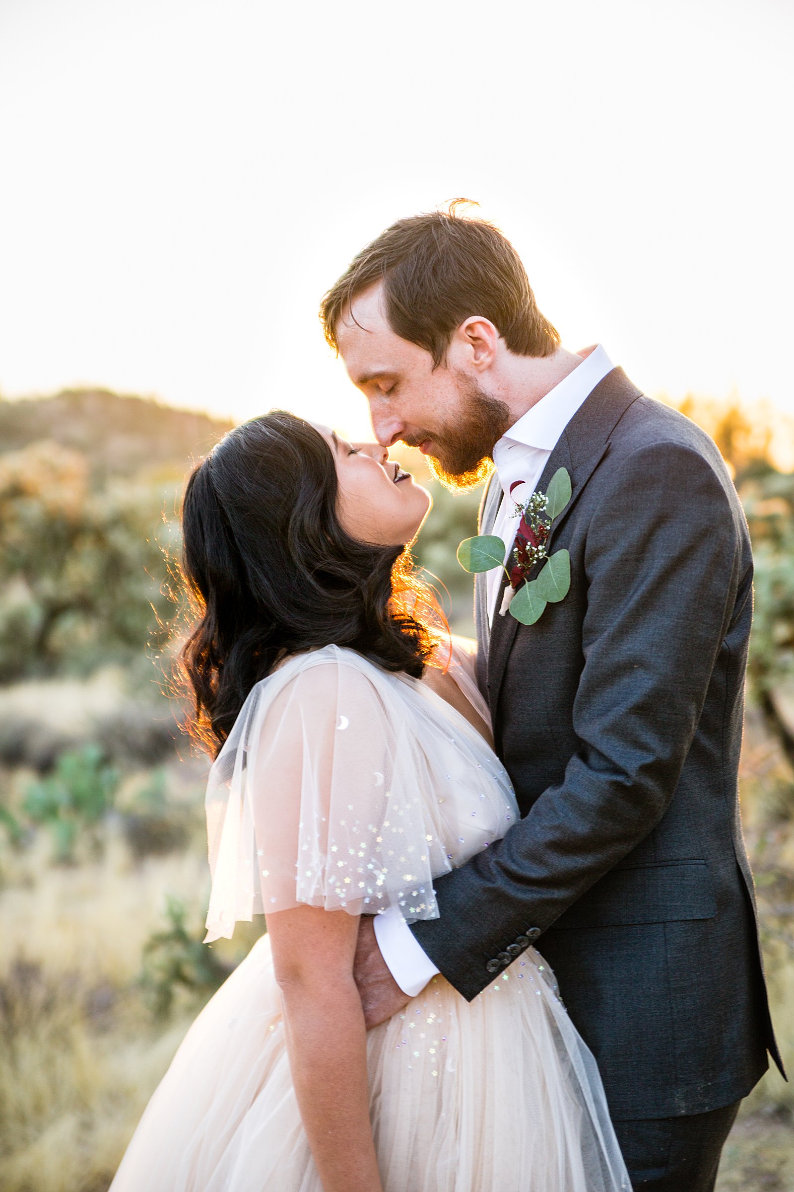 Bride and Groom share an intimate moment during their Superstition Mountain Cloth and Flame wedding by Mesa wedding photographer PMA Photography.