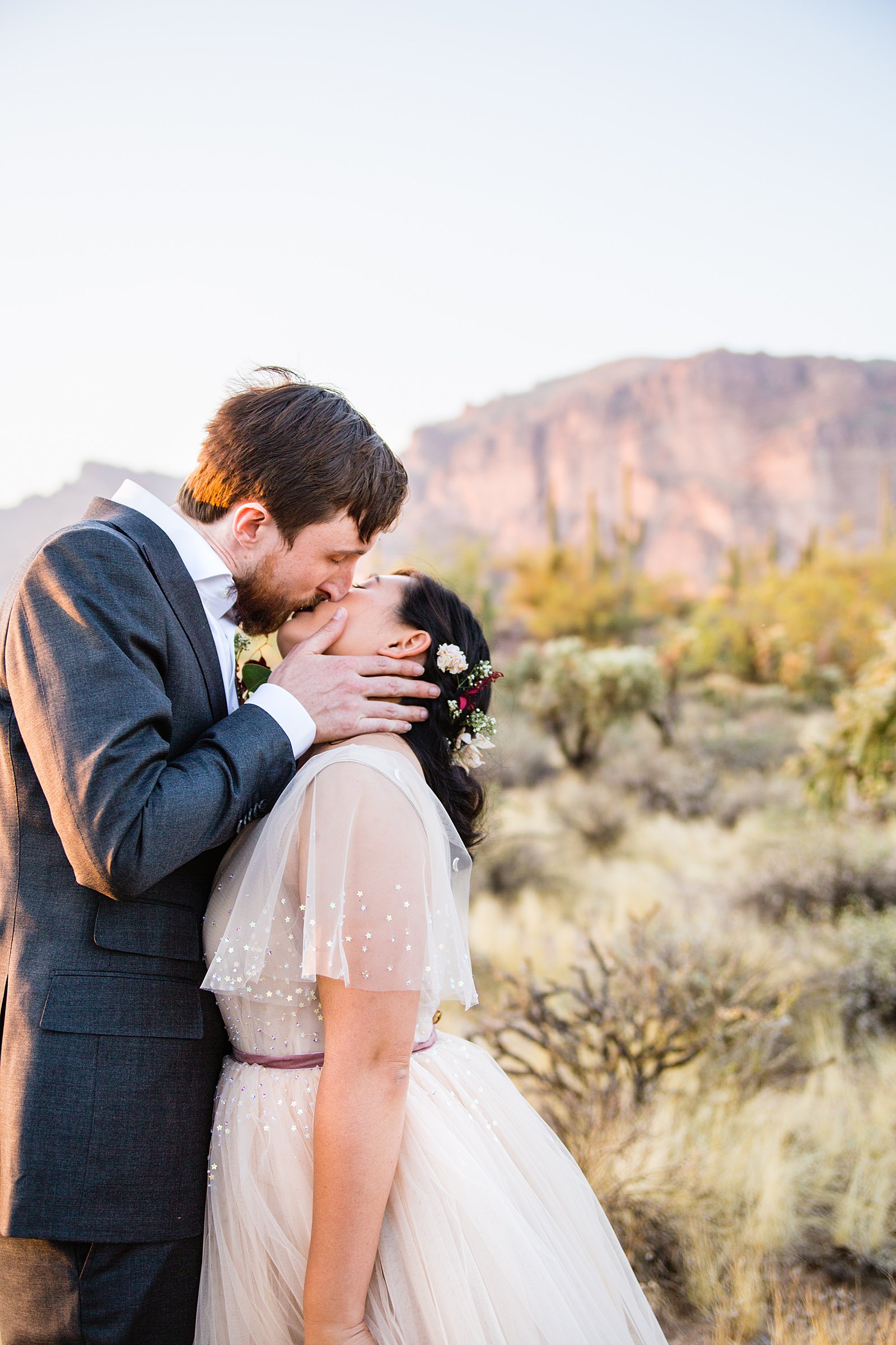 Bride and Groom share a kiss during their Superstition Mountain Cloth and Flame wedding by Arizona wedding photographer PMA Photography.