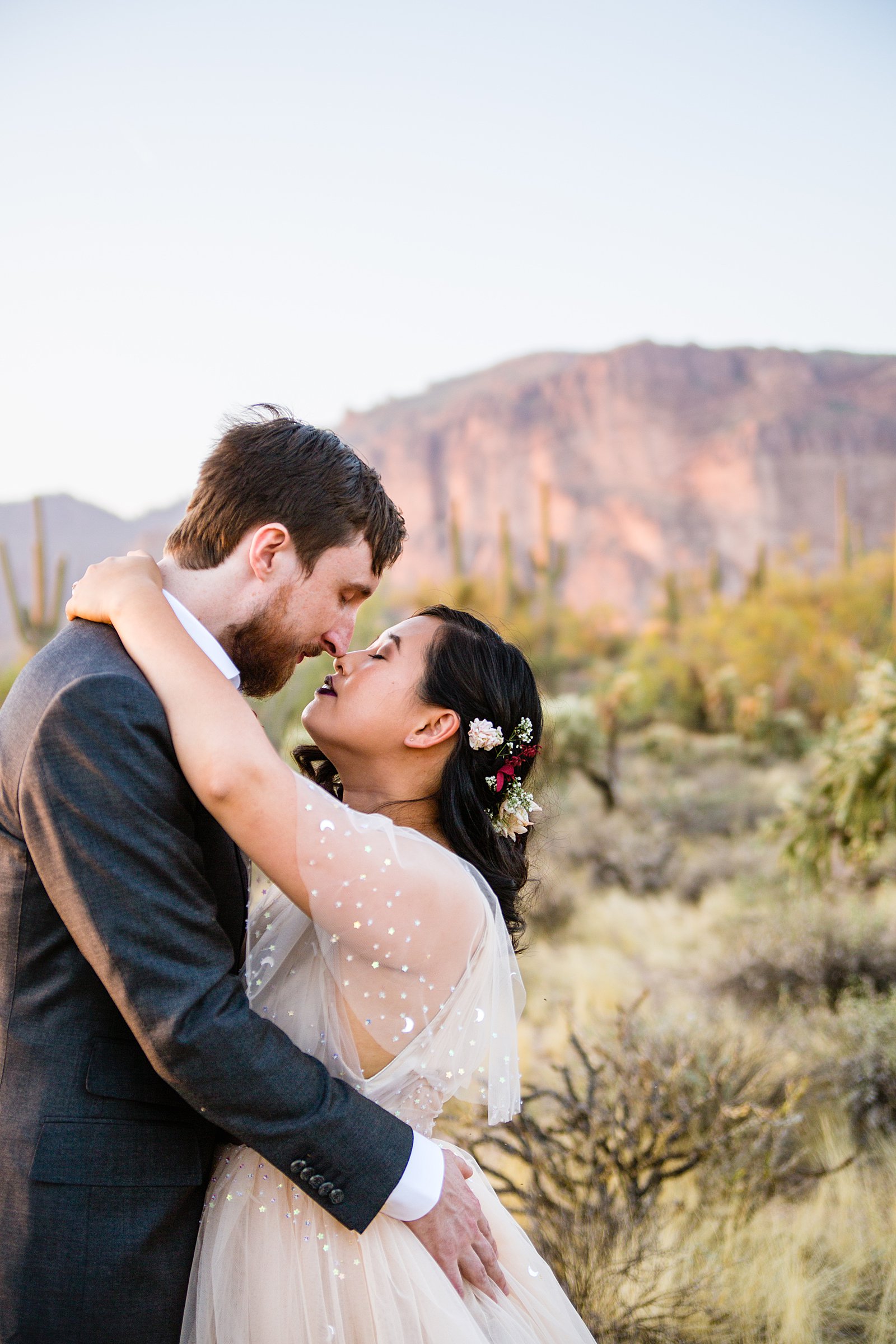 Bride and Groom share an intimate moment during their Superstition Mountain Cloth and Flame wedding by Mesa wedding photographer PMA Photography.