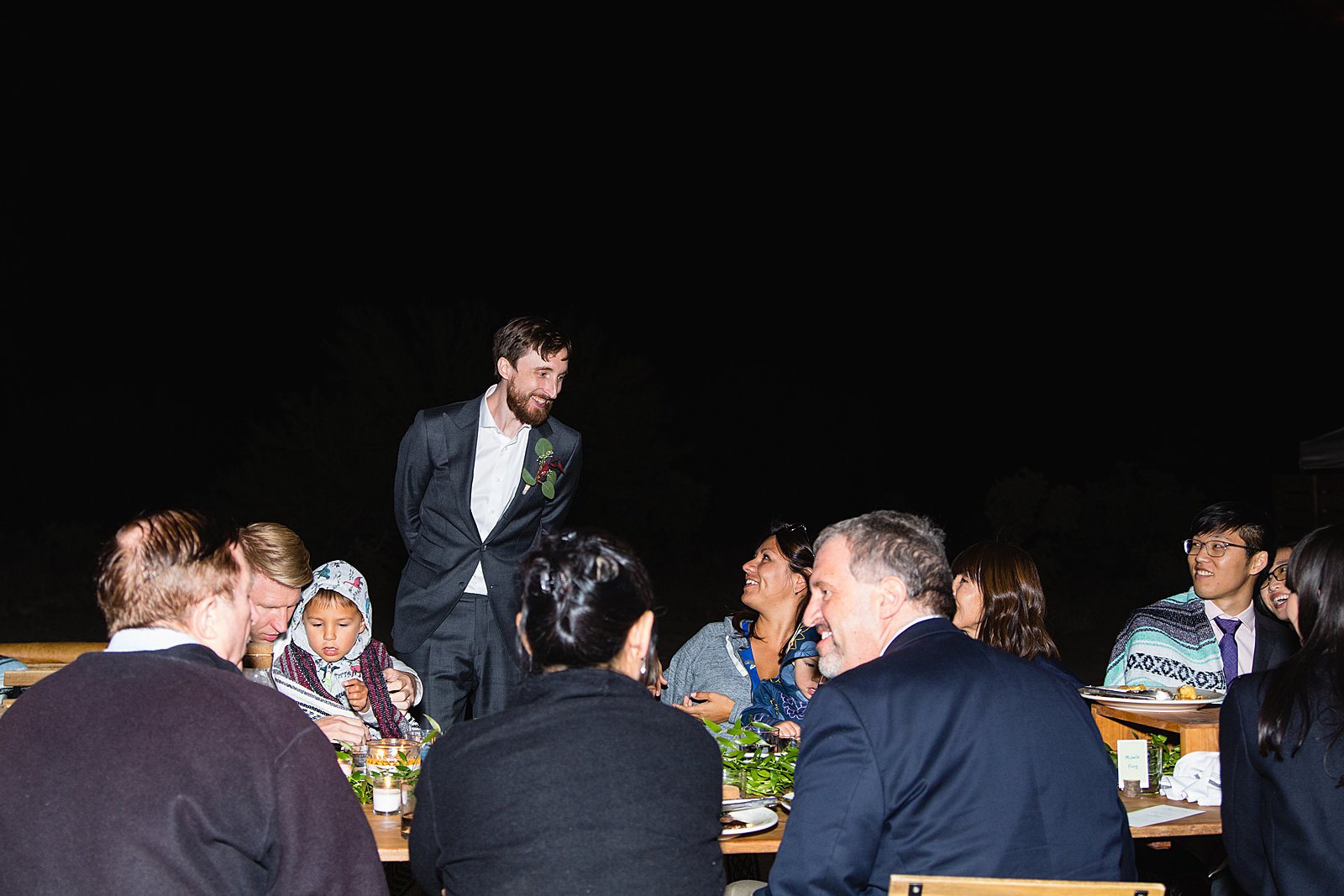 Groom mingling with guests at a Cloth and Flame wedding reception by Phoenix wedding photographer PMA Photography.