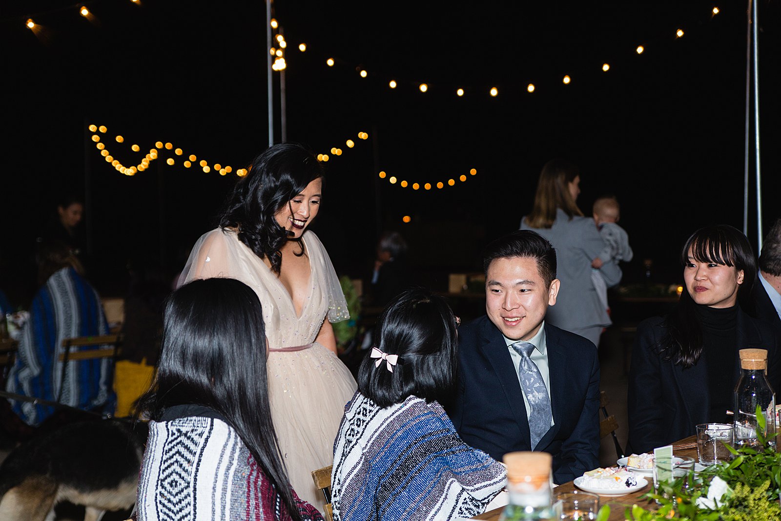 Bride mingling with guests at a Cloth and Flame wedding reception by Phoenix wedding photographer PMA Photography.
