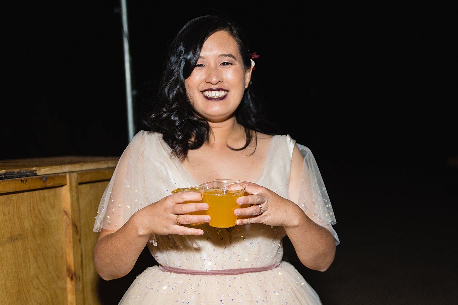 Bride holding custom cocktails at her Cloth and Flame wedding by PMA Photography.