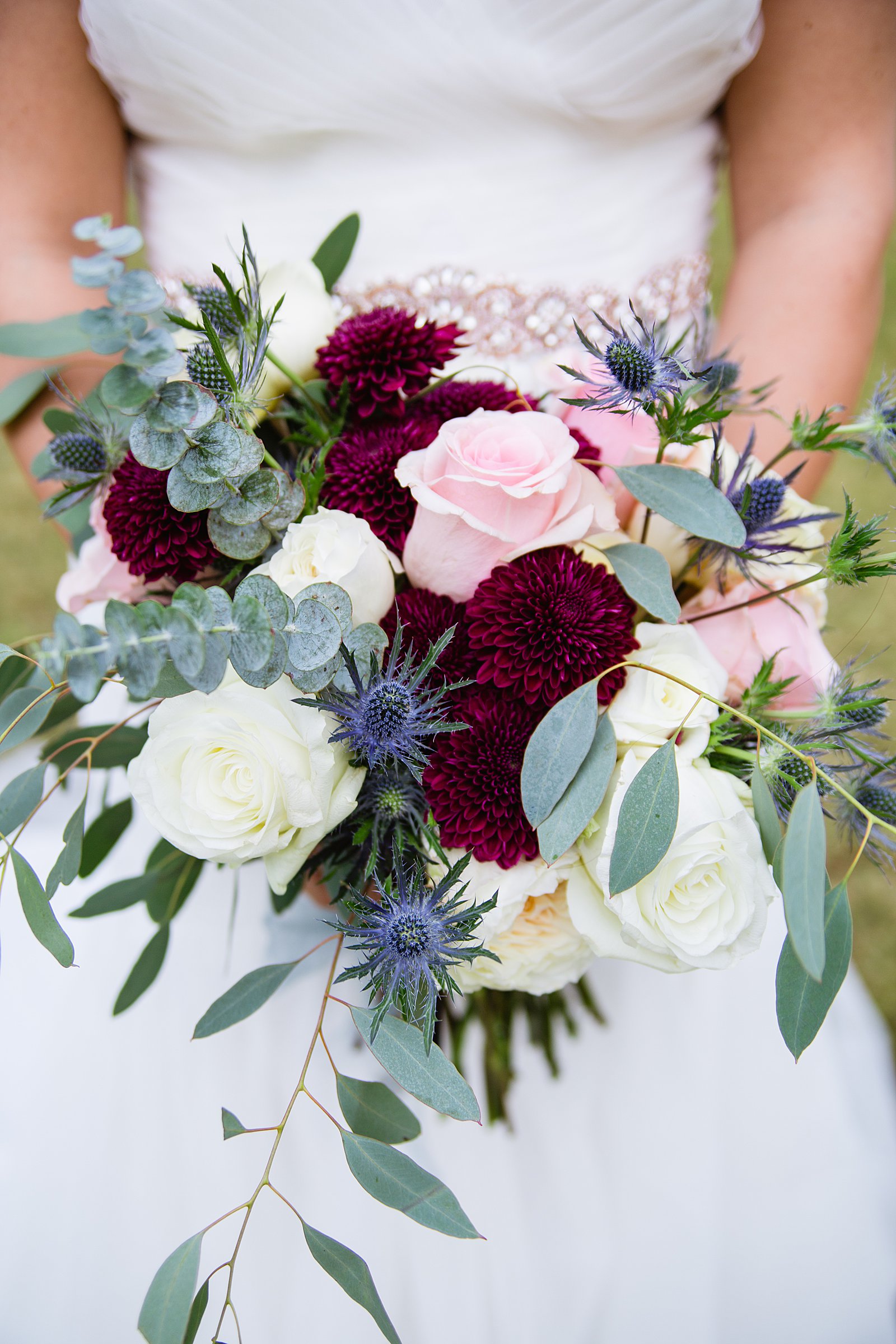 Bride's romantic white, green, pink, and maroon bouquet by PMA Photography.
