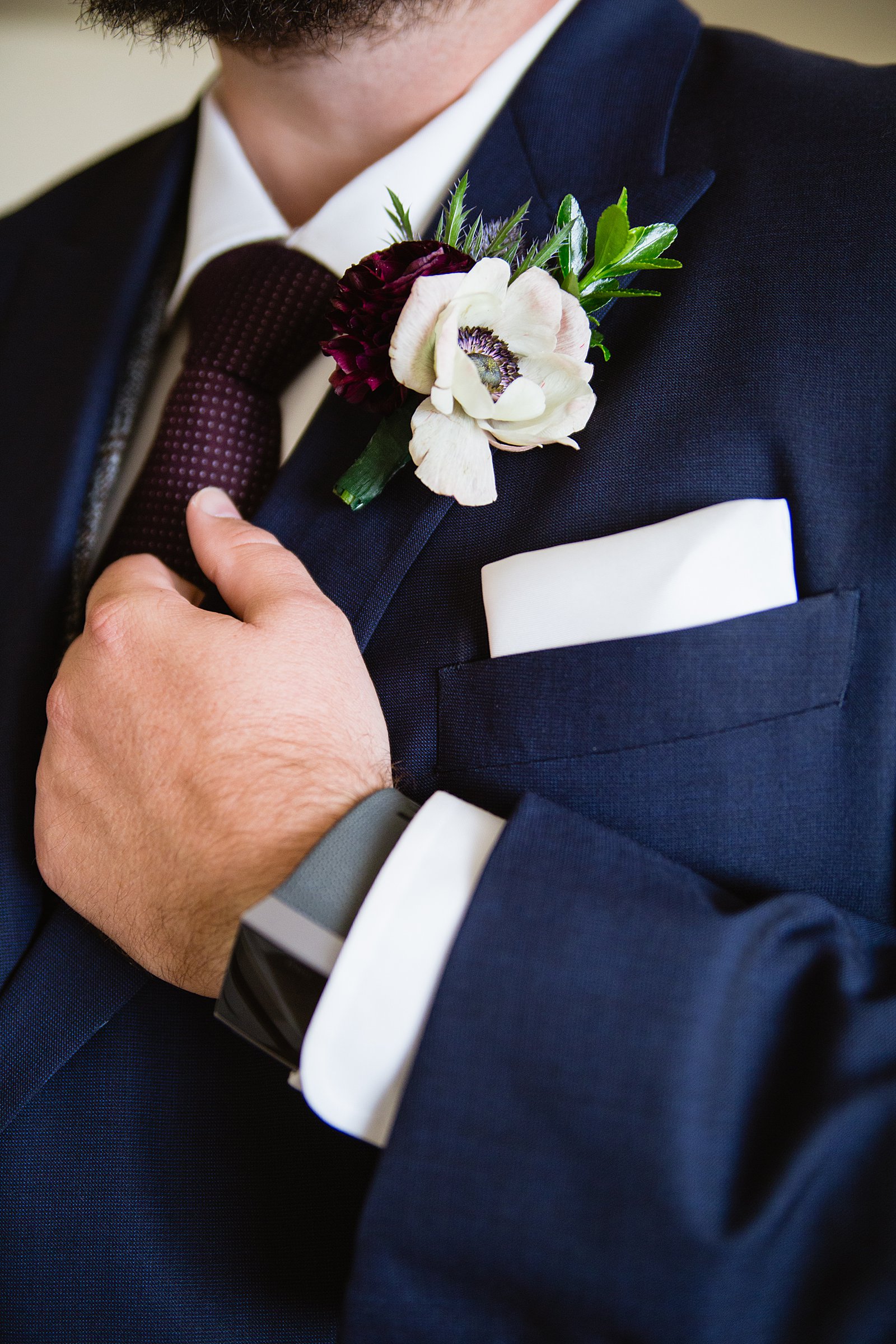 Groom's romantic white and maroon boutonniere by PMA Photography.