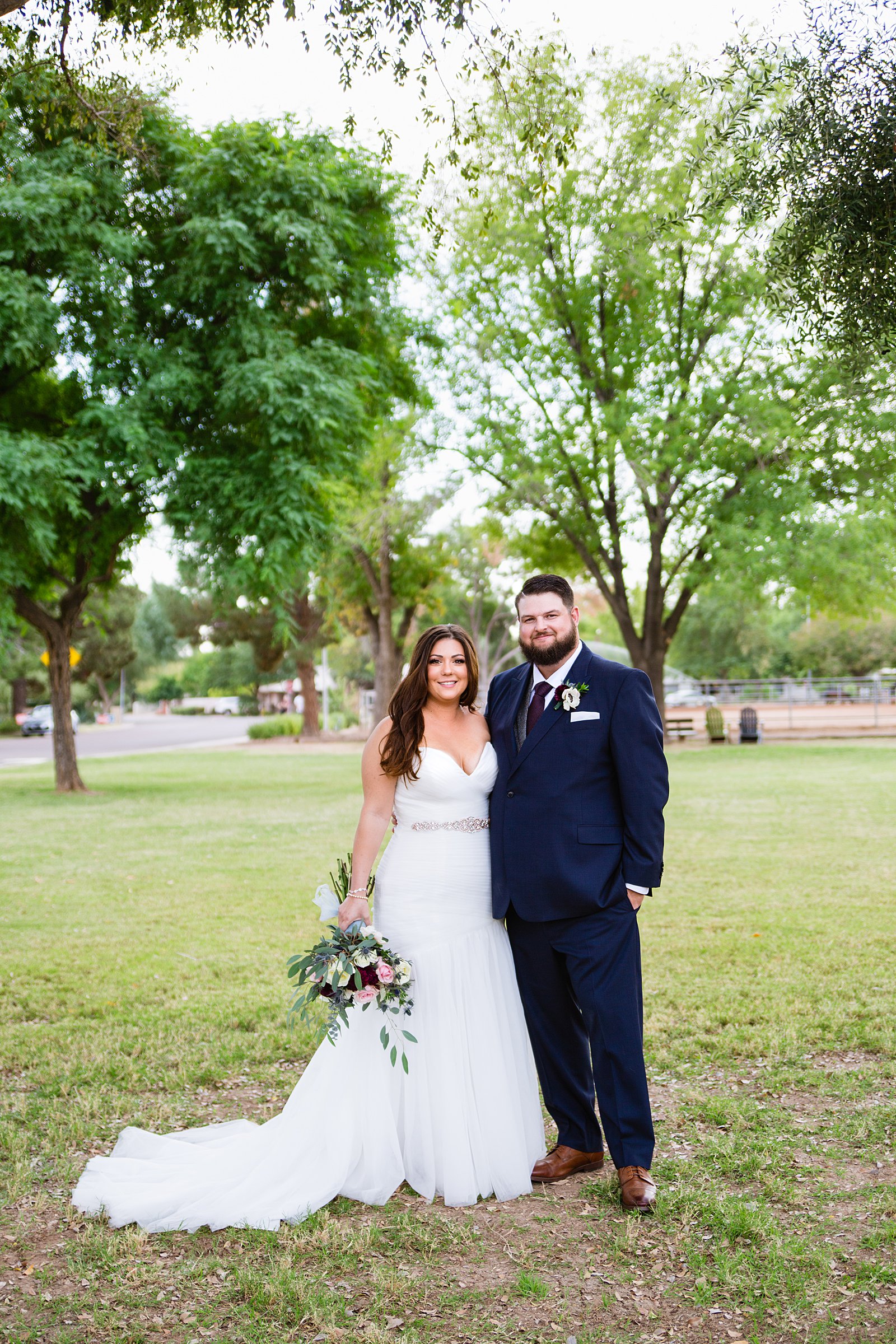 Bride and Groom pose during their Arizona backyard wedding by Arizona wedding photographer PMA Photography.