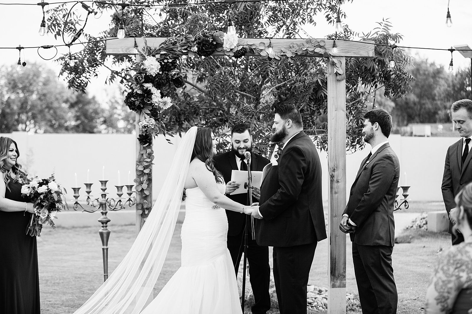 Bride and Groom togethering during an Arizona backyard wedding ceremony by Tempe wedding photographer PMA Photography.