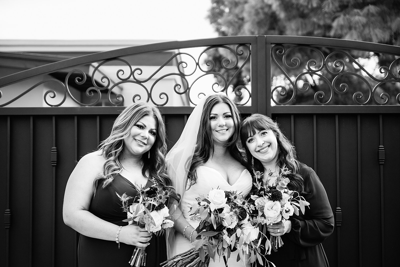 Bride and bridesmaids together at a Arizona backyard wedding by Arizona wedding photographer PMA Photography.