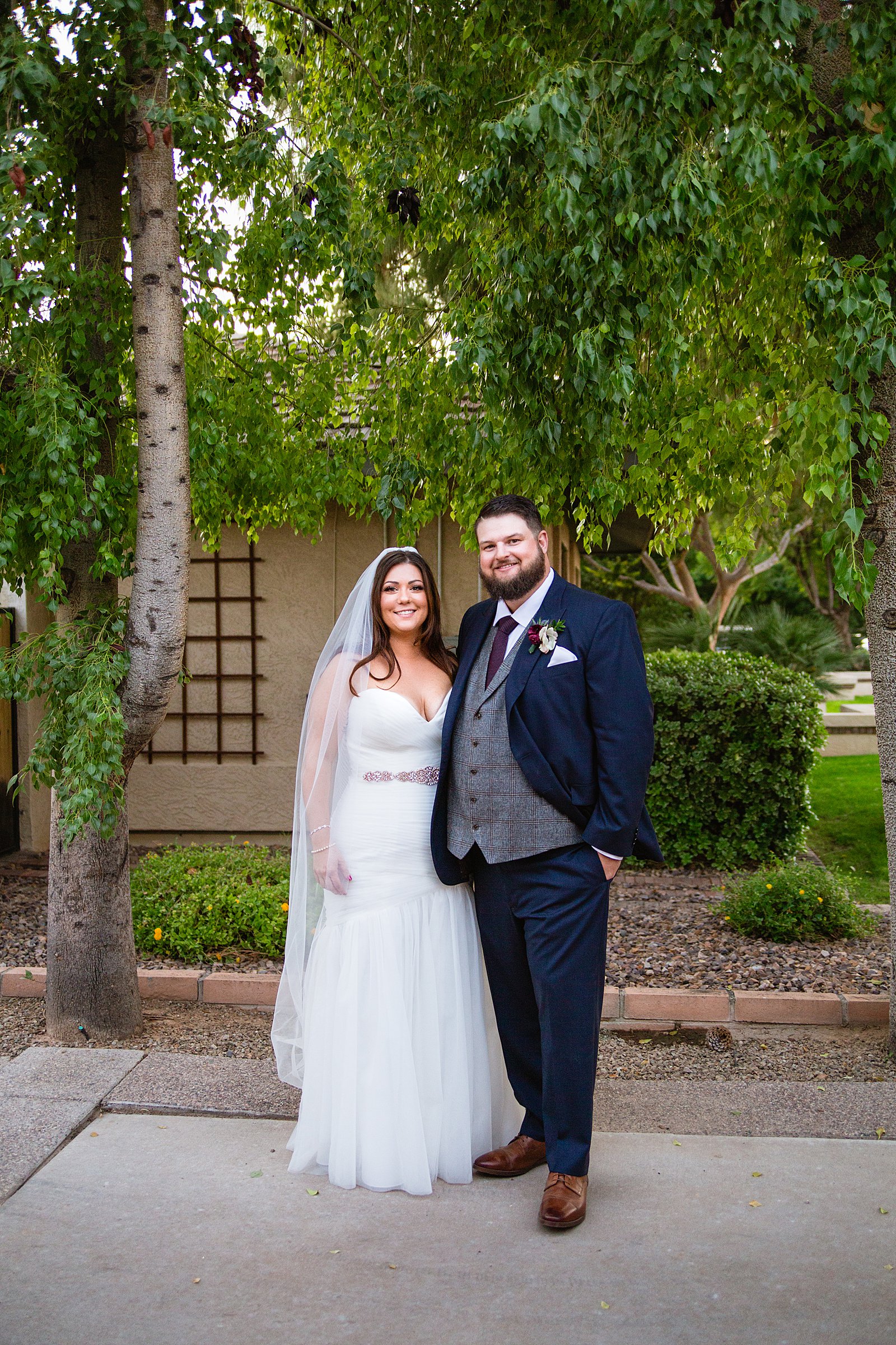 Bride and Groom pose during their Arizona backyard wedding by Arizona wedding photographer PMA Photography.