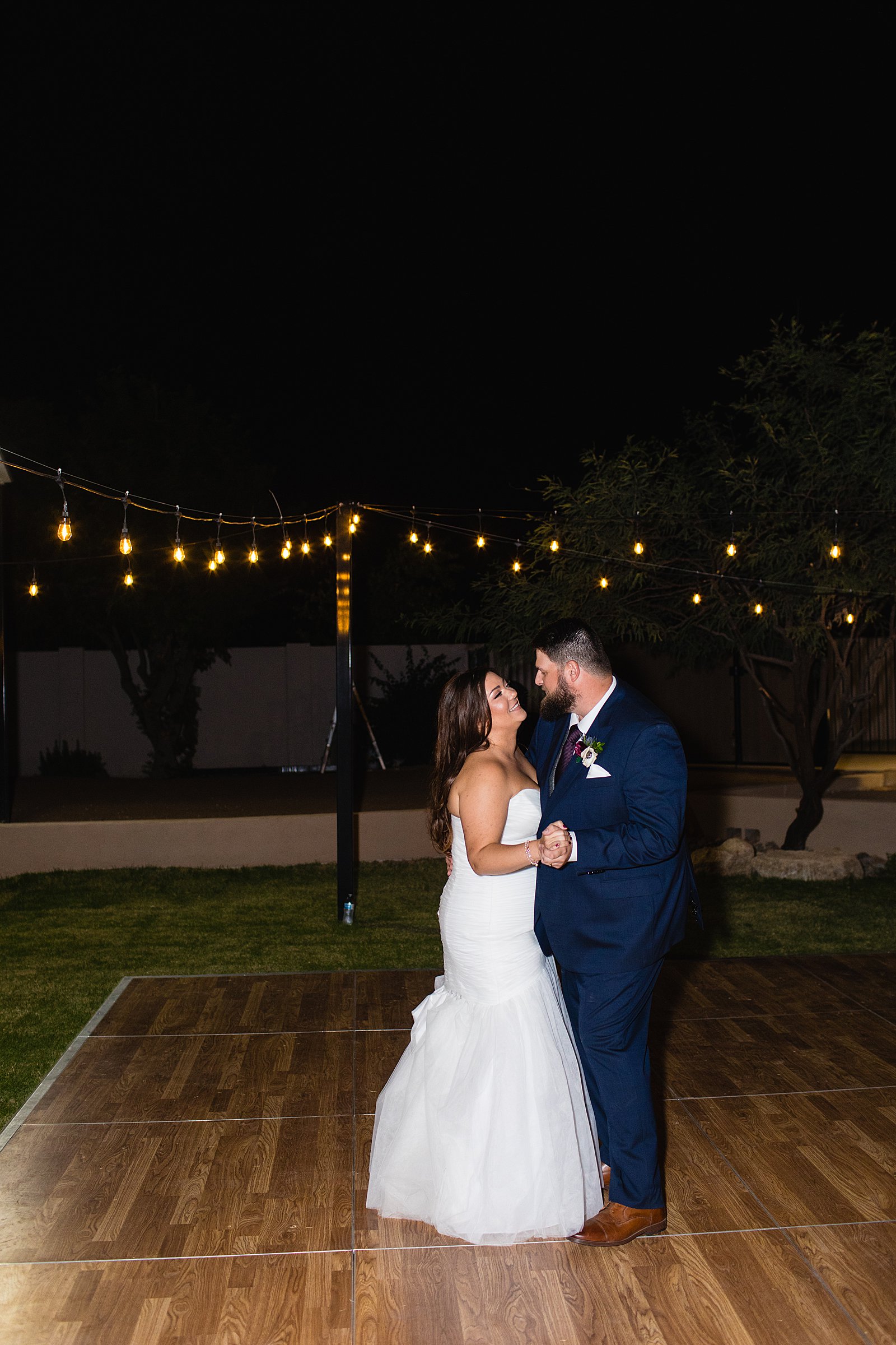 Bride and Groom sharing first dance at their Arizona backyard wedding reception by Arizona wedding photographer PMA Photography.