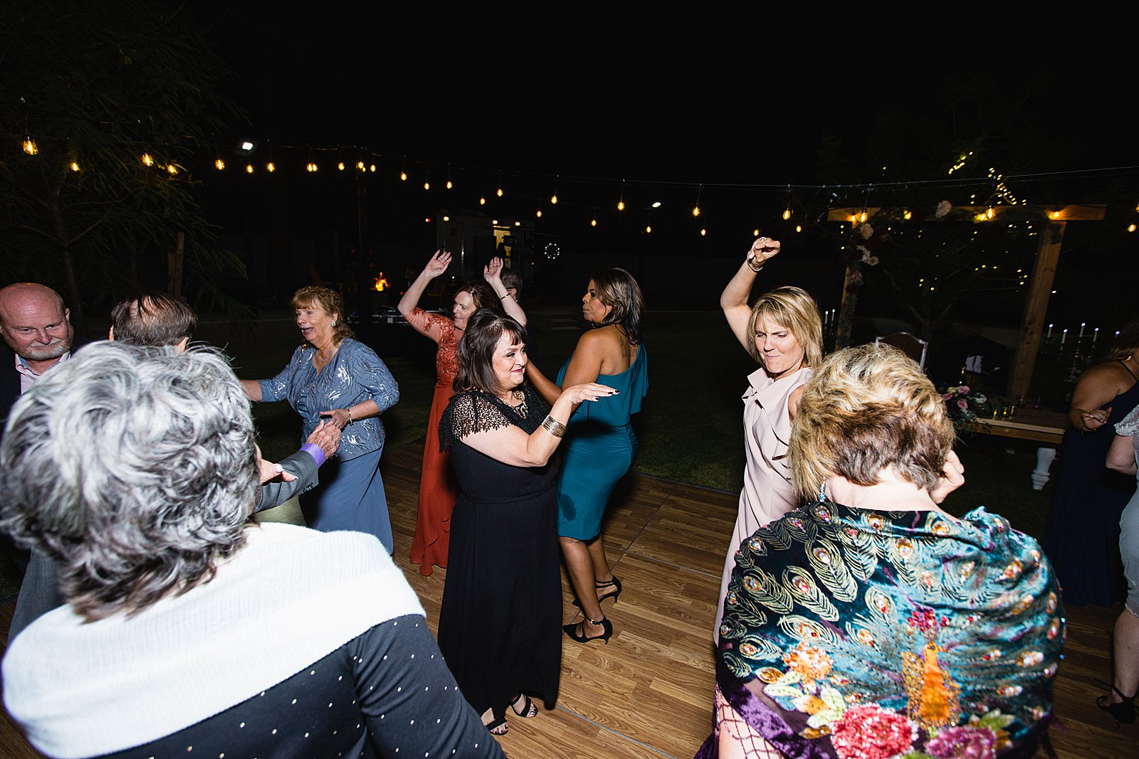 Guests dancing at an Arizona backyard wedding reception by Tempe wedding photographer PMA Photography