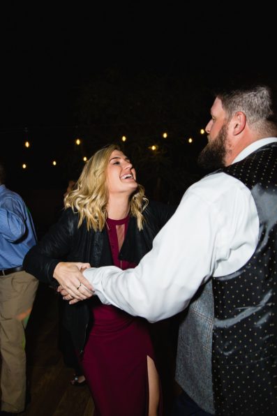 Groom dancing with guests at Arizona backyard wedding wedding reception by Tempe wedding photographer PMA Photography
