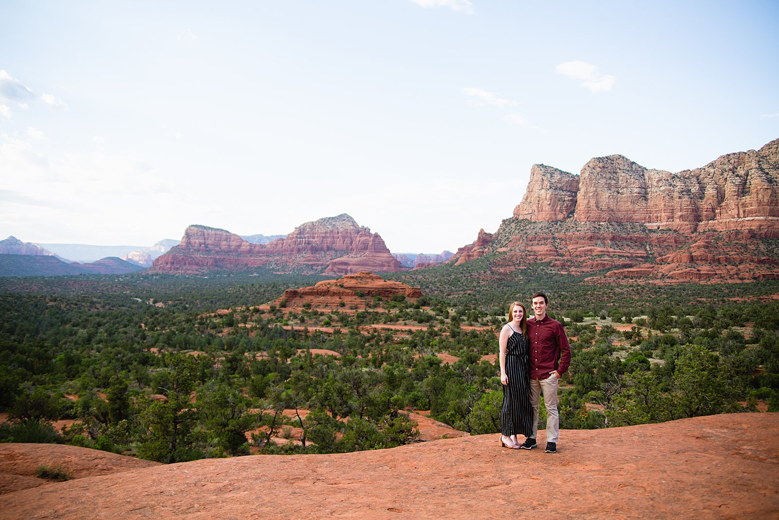 Adventurous couple pose during their Sedona engagement session by Arizona wedding photographer PMA Photography.