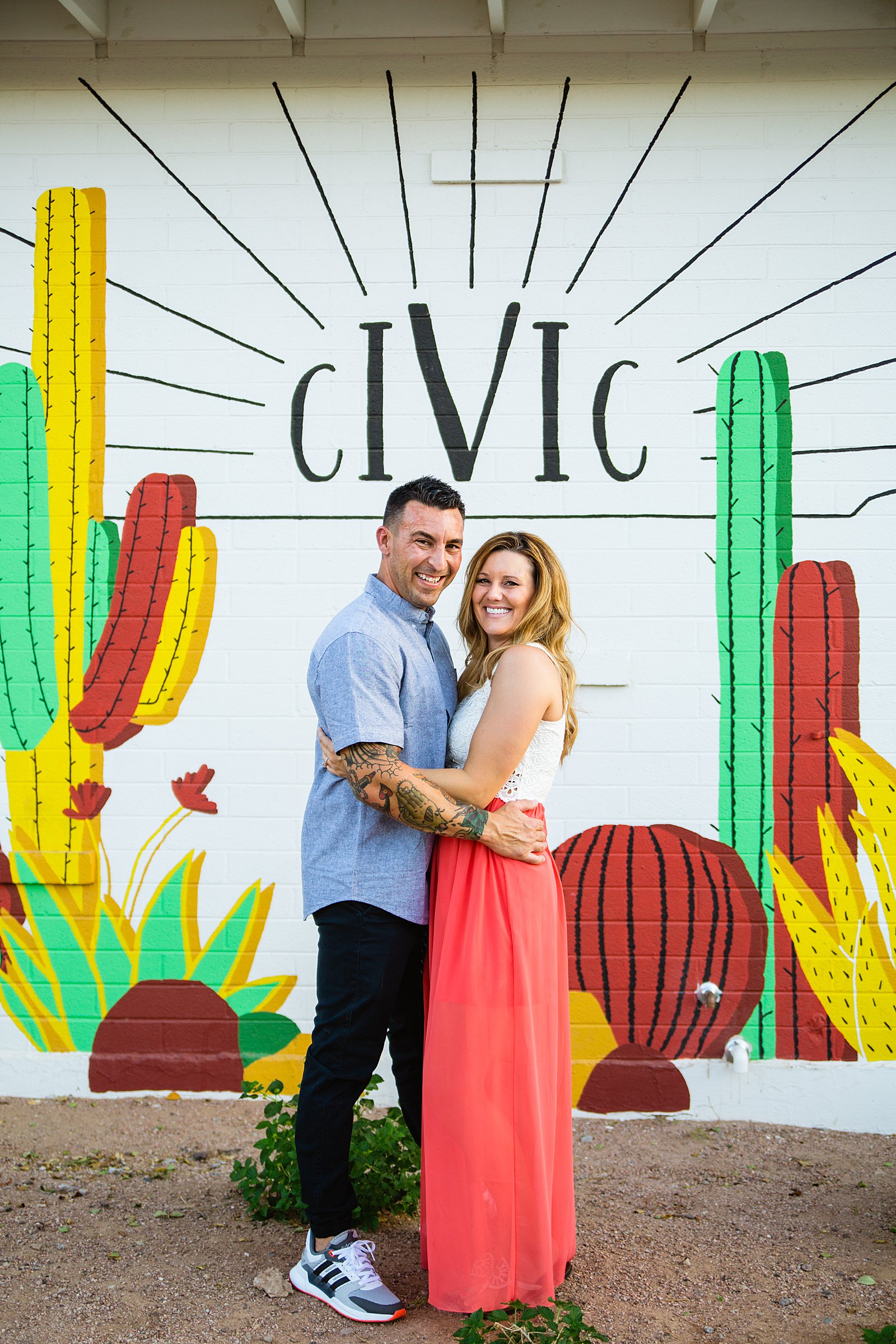 Couple pose during their Chandler engagement session by Arizona wedding photographer PMA Photography.