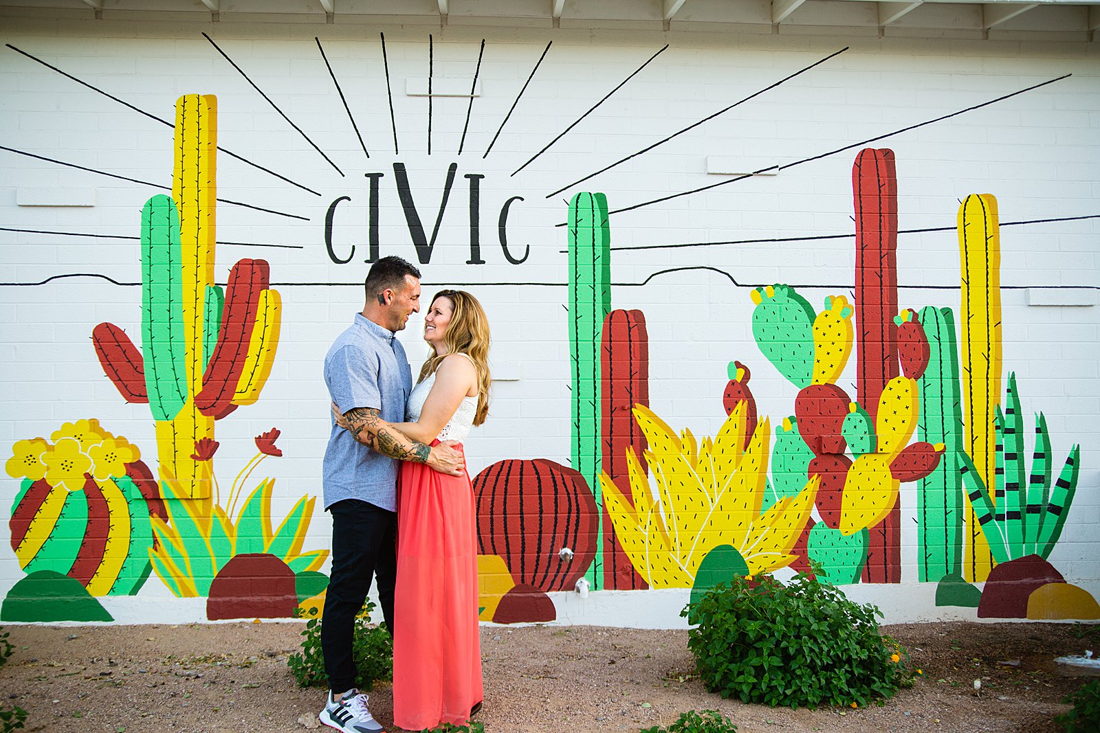 Couple look at each other during their Chandler engagement session by Arizona wedding photographer PMA Photography.