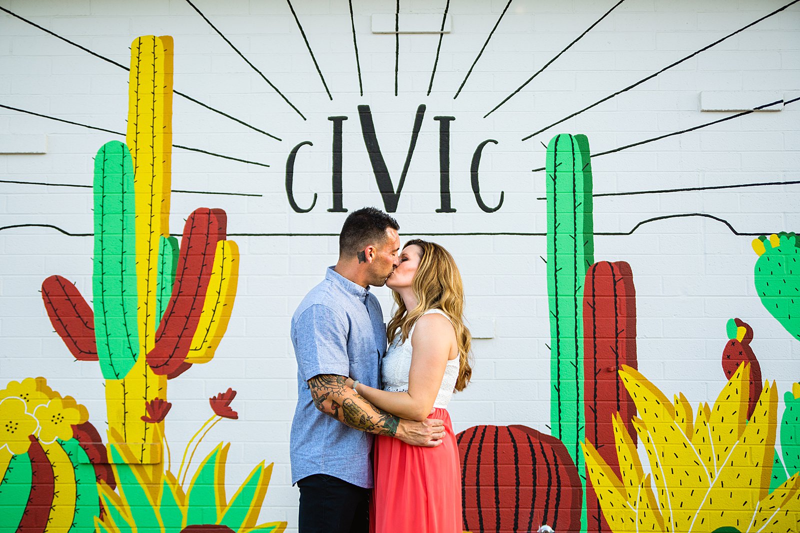 Couple share a kiss during their Chandler engagement session by Arizona wedding photographer PMA Photography.