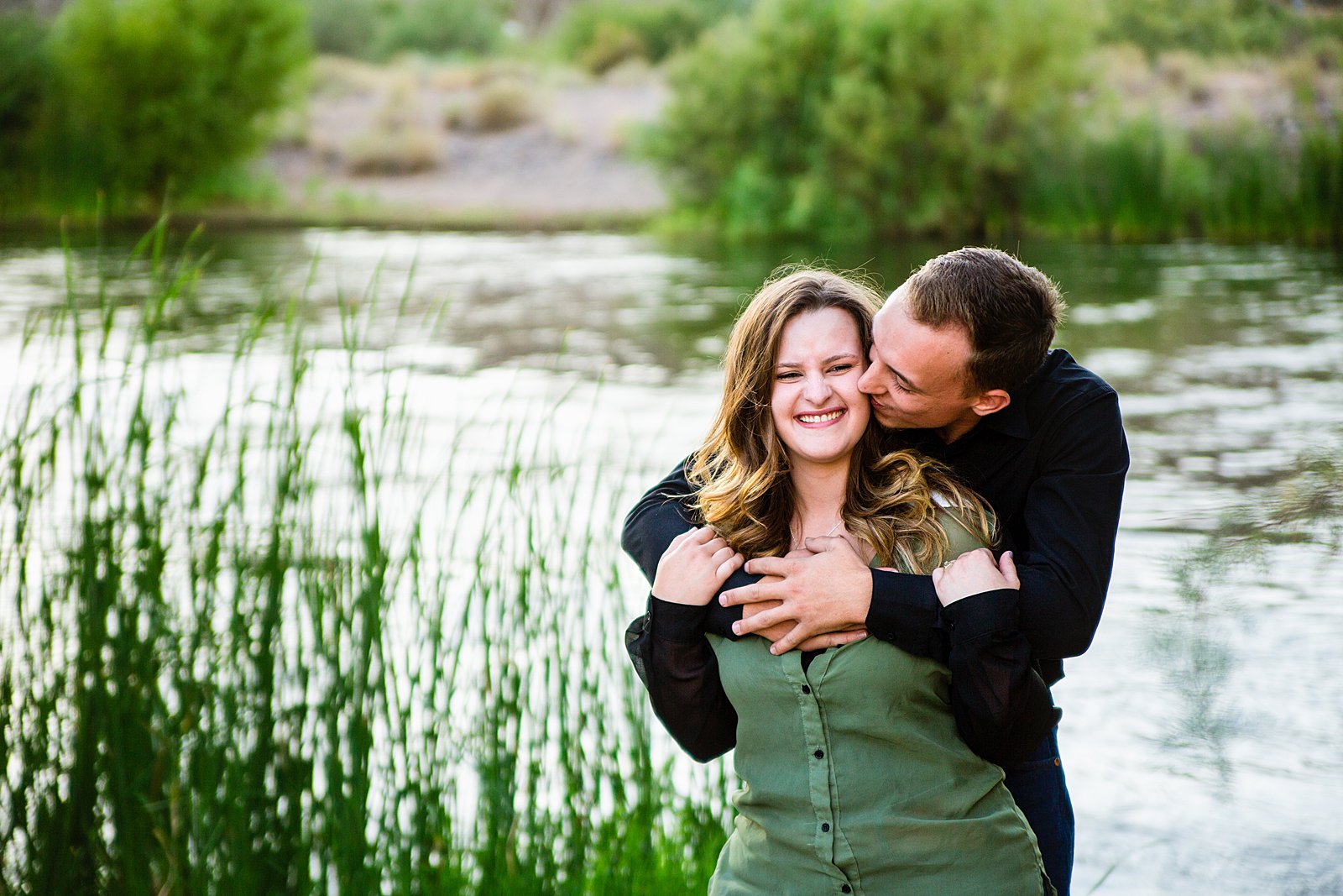 Couple laugh together during their Salt River engagement session by Phoenix engagement photographer PMA Photography.