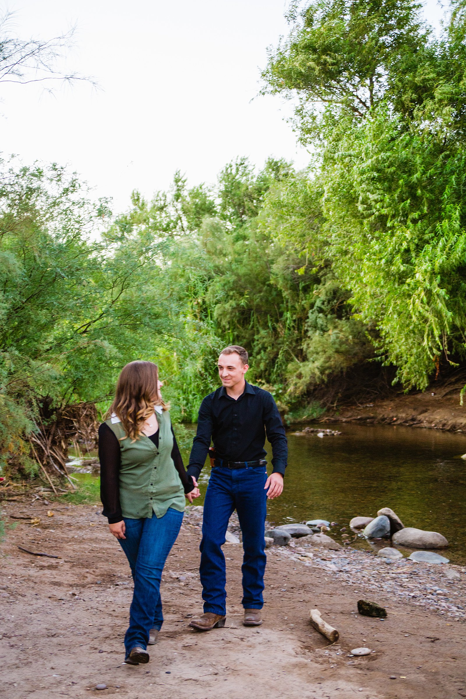 Couple walking together during their Salt River engagement session by Phoenix engagement photographer PMA Photography.