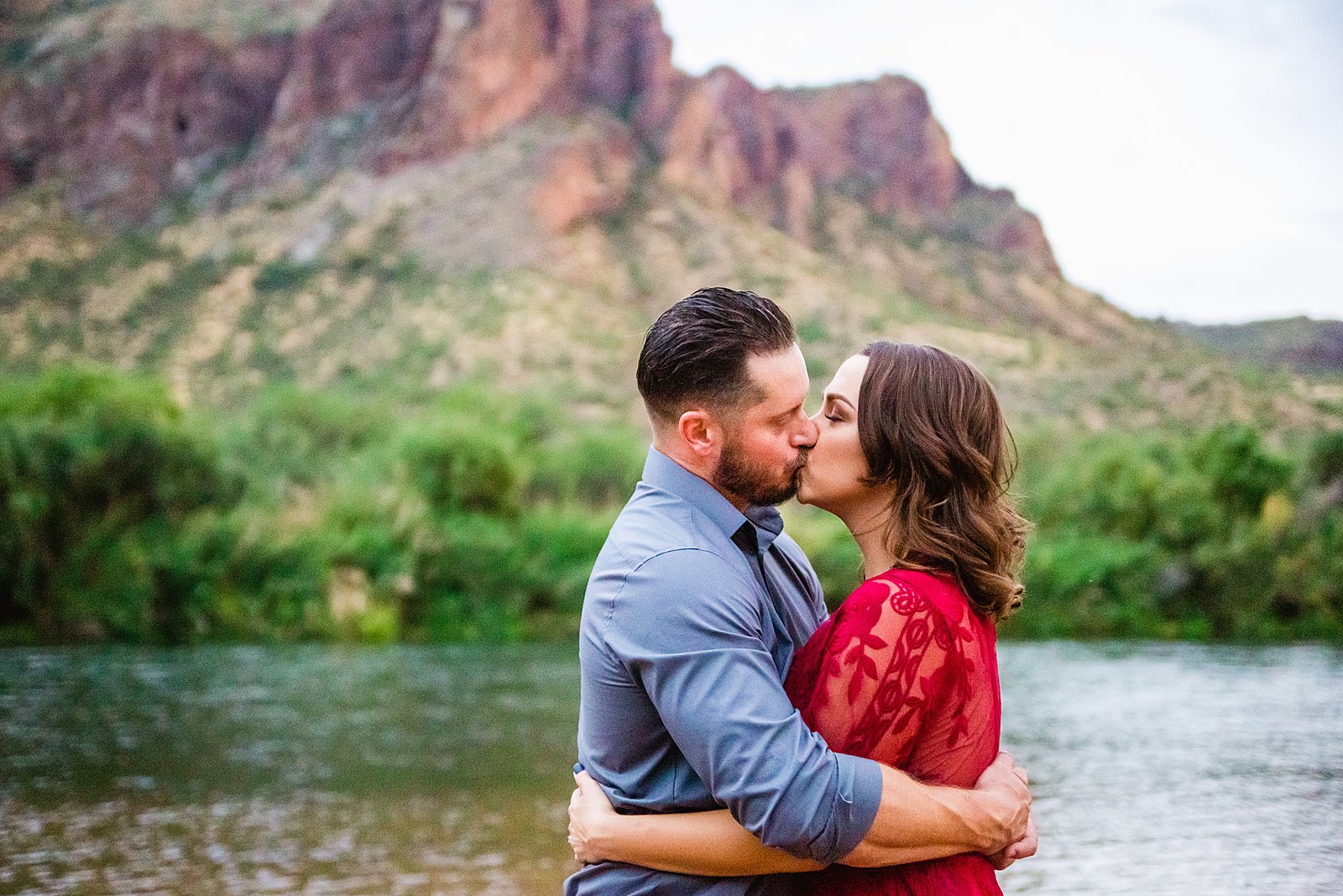 Couple share a kiss during their Salt River engagement session by Phoenix wedding photographer PMA Photography.