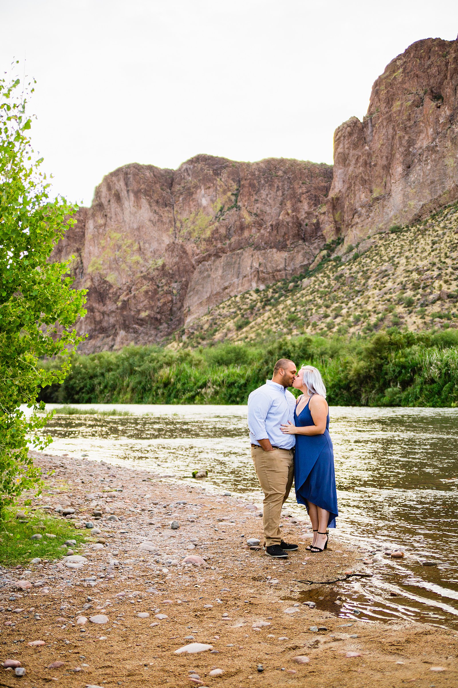 Couple share a kiss during their Salt River engagement session by Phoenix wedding photographer PMA Photography.