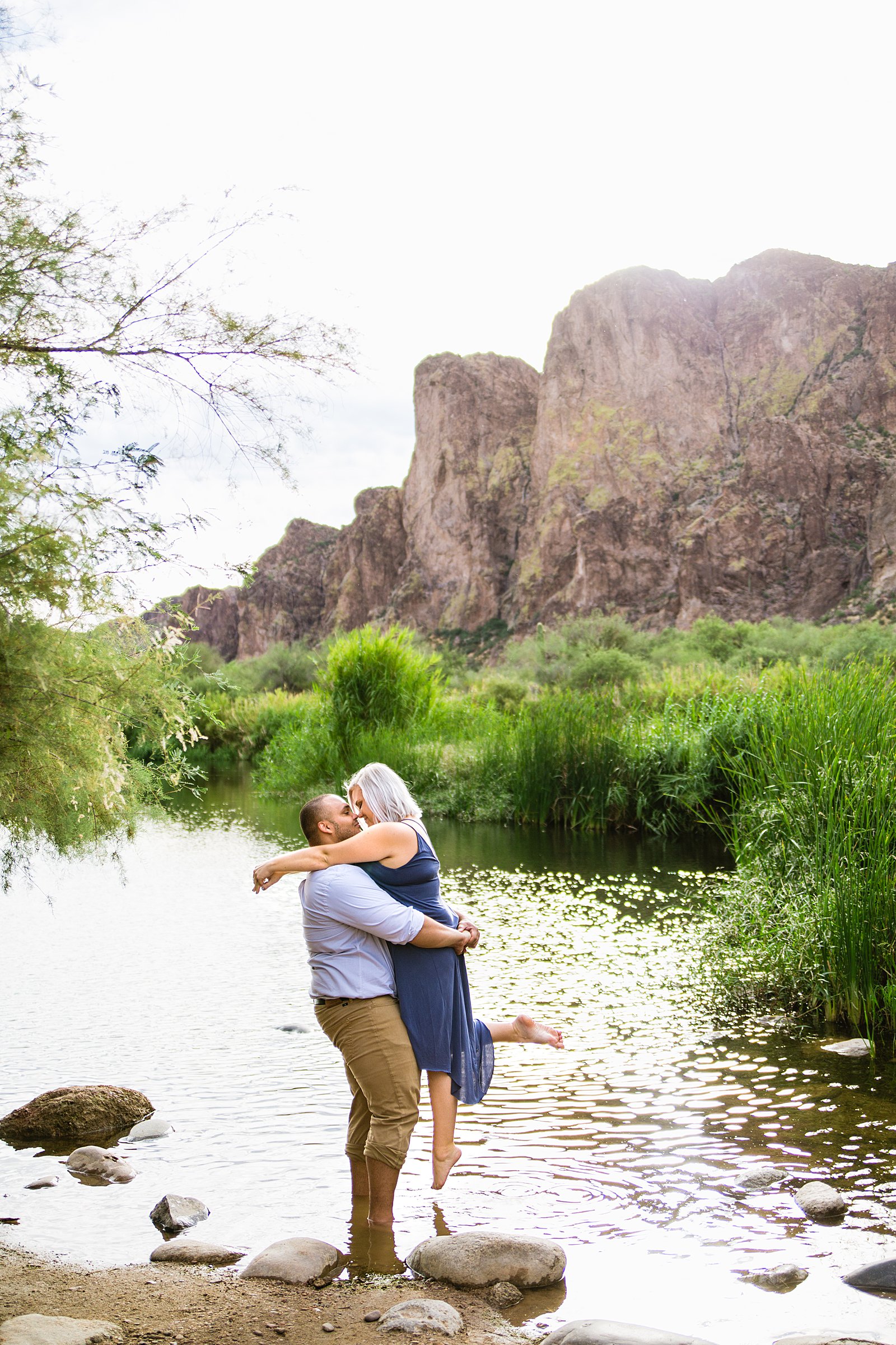 Adventurous couple share an intimate moment during their Salt River engagement session by Phoenix engagement photographer PMA Photography.