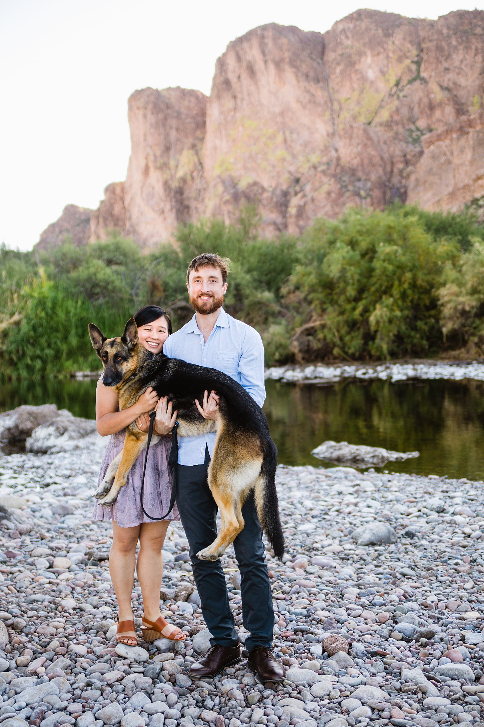 Couple holding their german shepherd during their Salt River engagement session by PMA Photography.