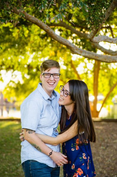 Couple laugh together during their Anthem Park engagement session by Phoenix engagement photographer PMA Photography.