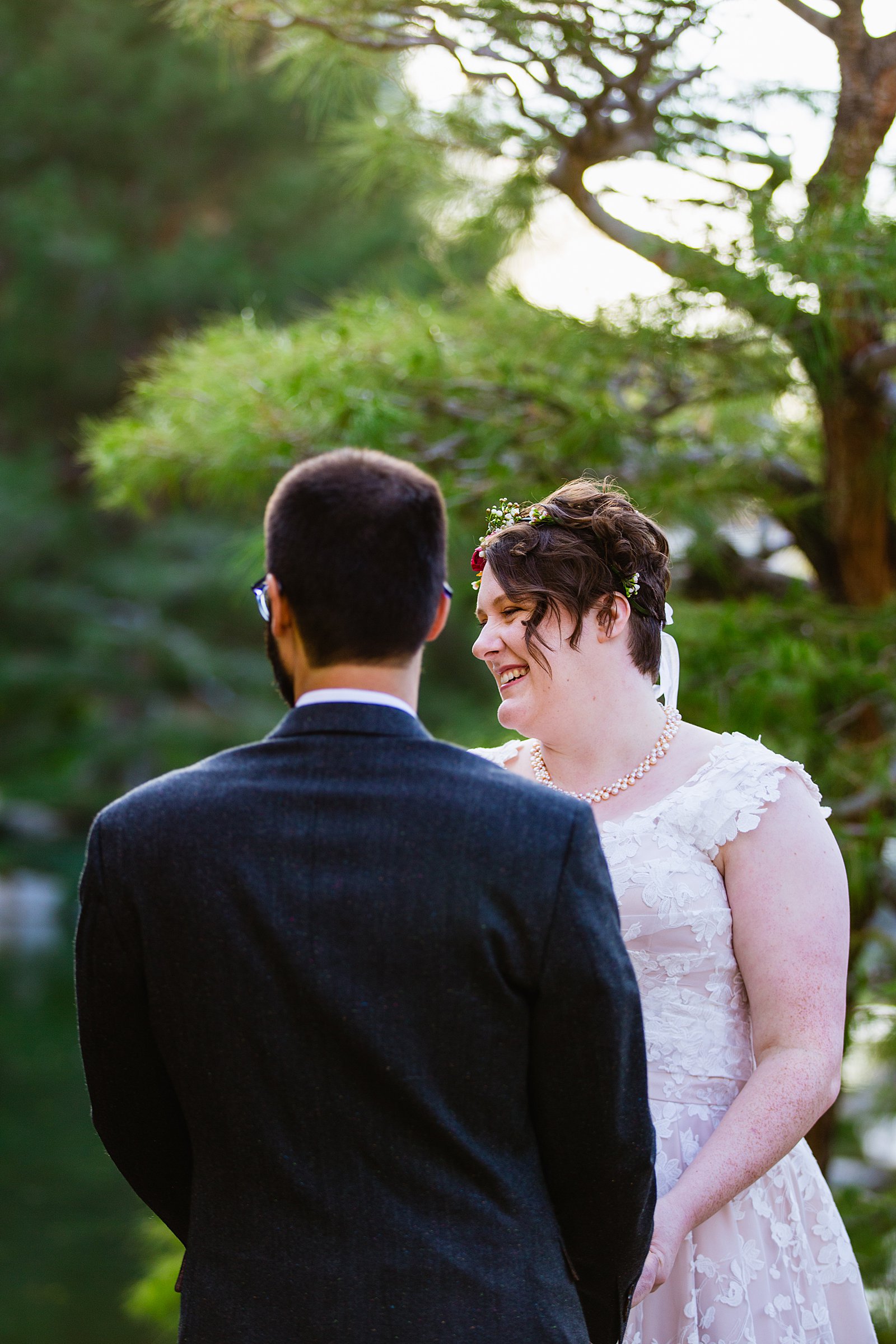 Bride laughing during her wedding ceremony at Japanese Friendship Garden by Phoenix wedding photographer PMA Photography.