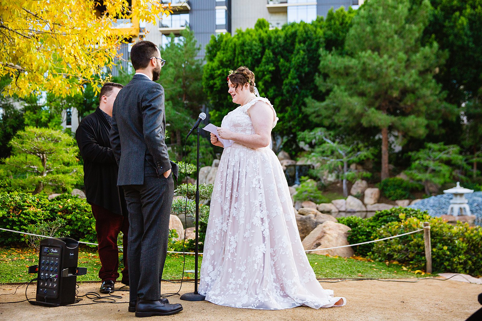 Bride reading vows to her groom during their wedding ceremony at Japanese Friendship Garden by Phoenix wedding photographer PMA Photography.