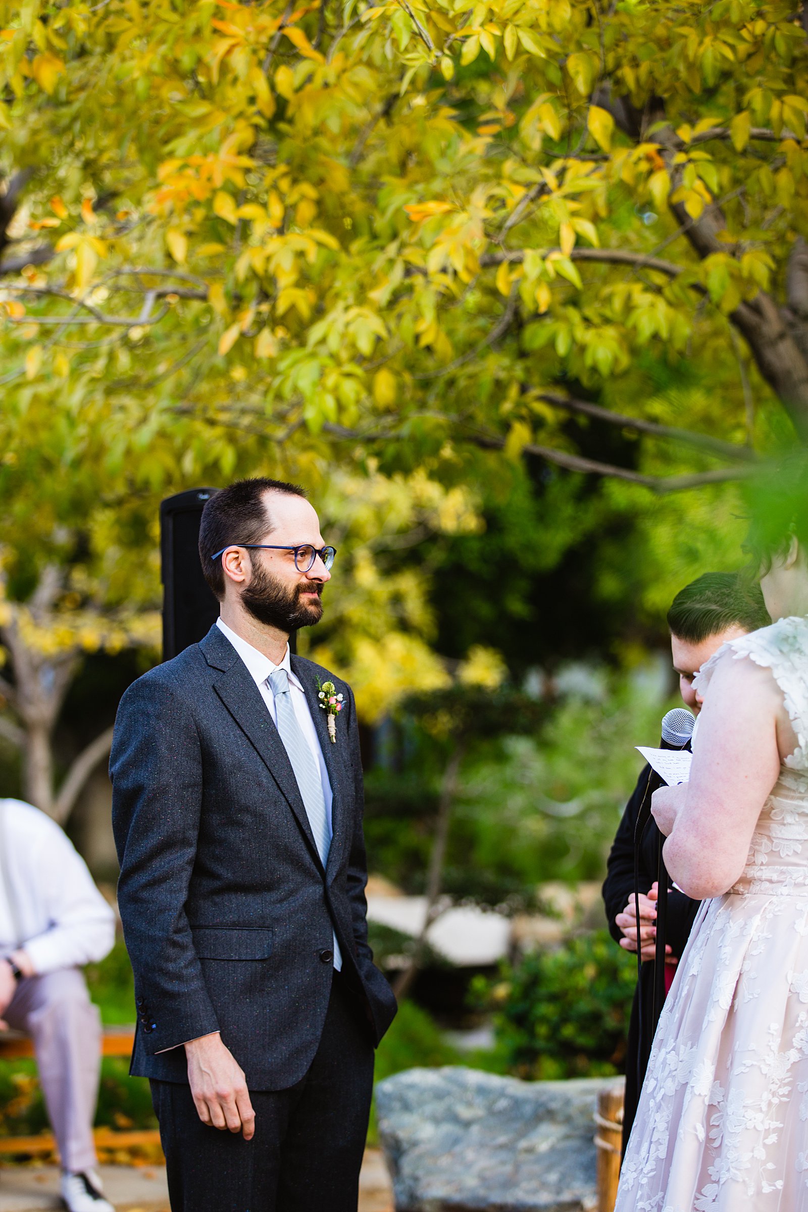 Groom looking at his bride during their wedding ceremony at Japanese Friendship Garden by Phoenix wedding photographer PMA Photography.