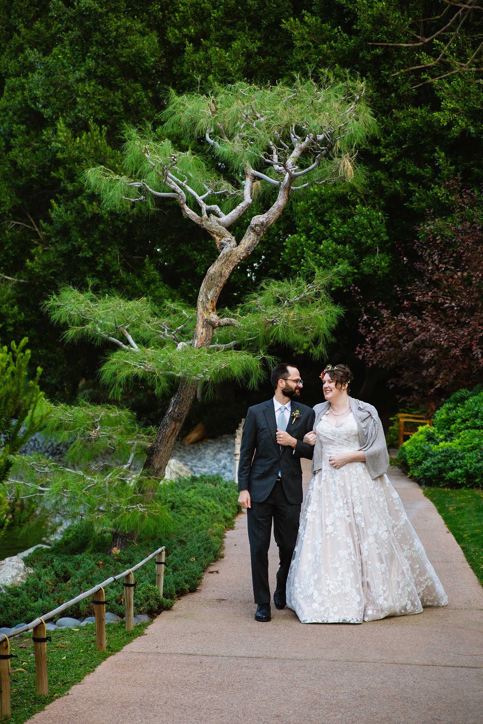 Bride and Groom walking together during their Japanese Friendship Garden wedding by Phoenix wedding photographer PMA Photography.