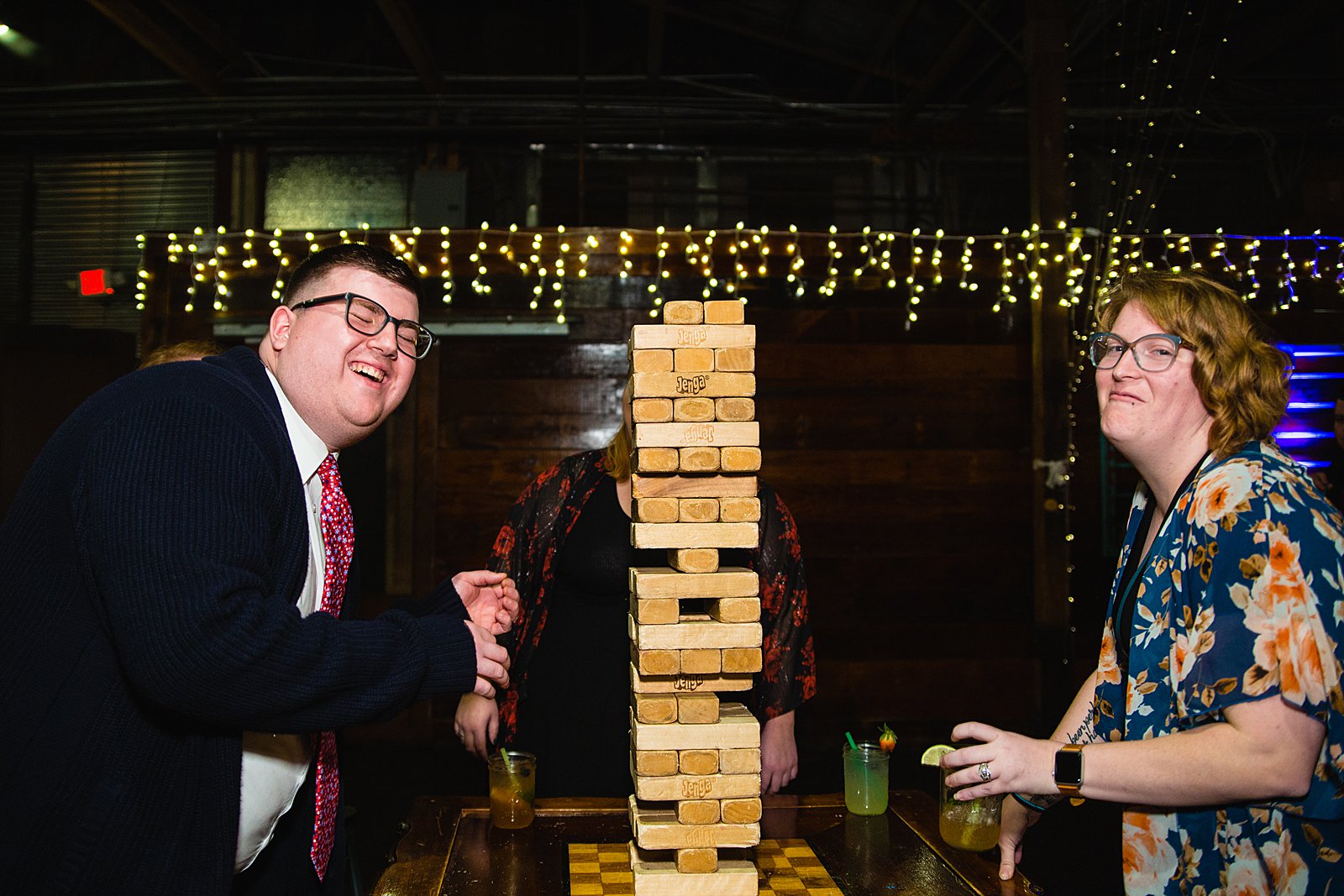 Guests playing jenga at a low key wedding reception at The Duce by PMA Photography.