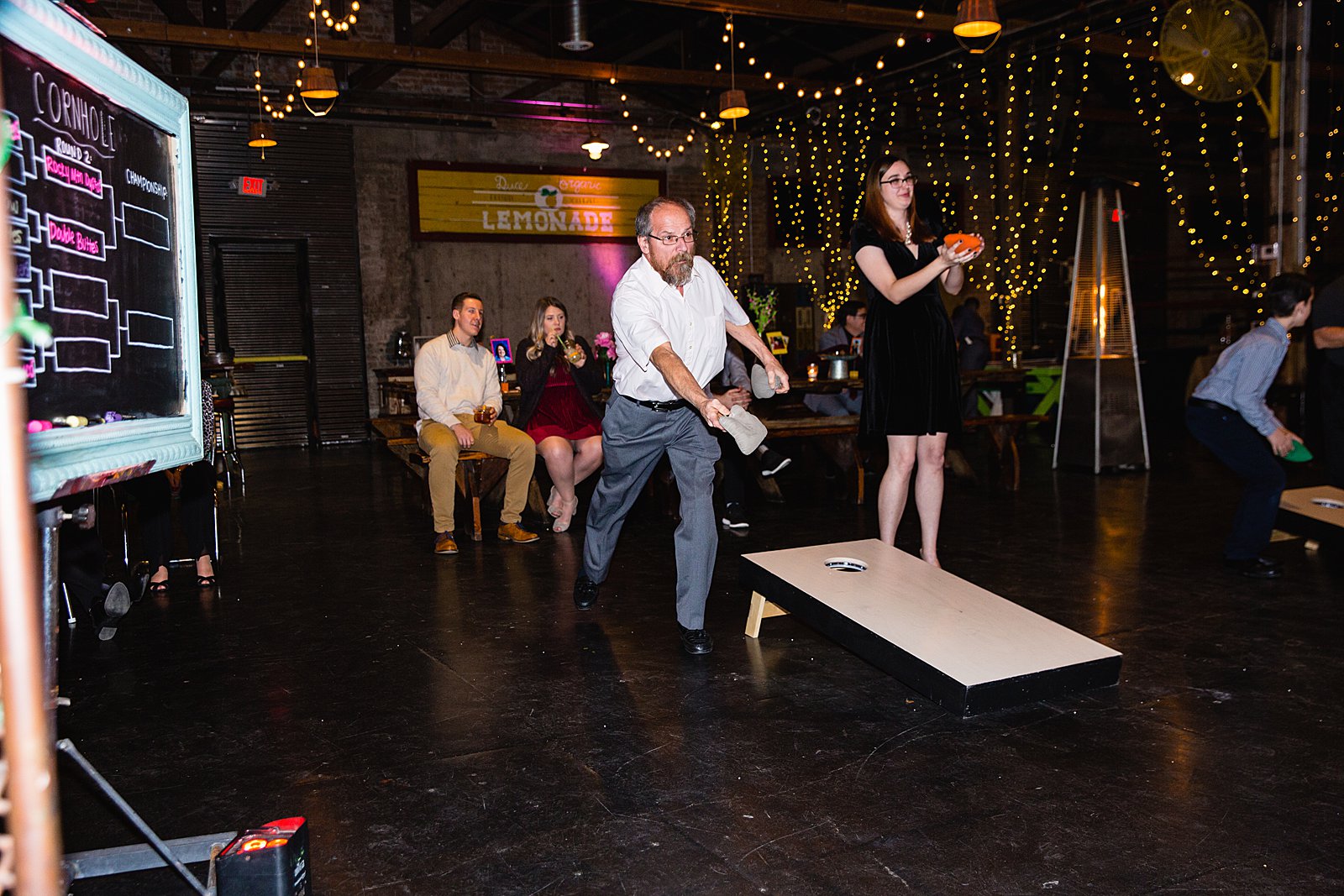 Guests playing corn hole at a low key wedding reception at The Duce by PMA Photography.
