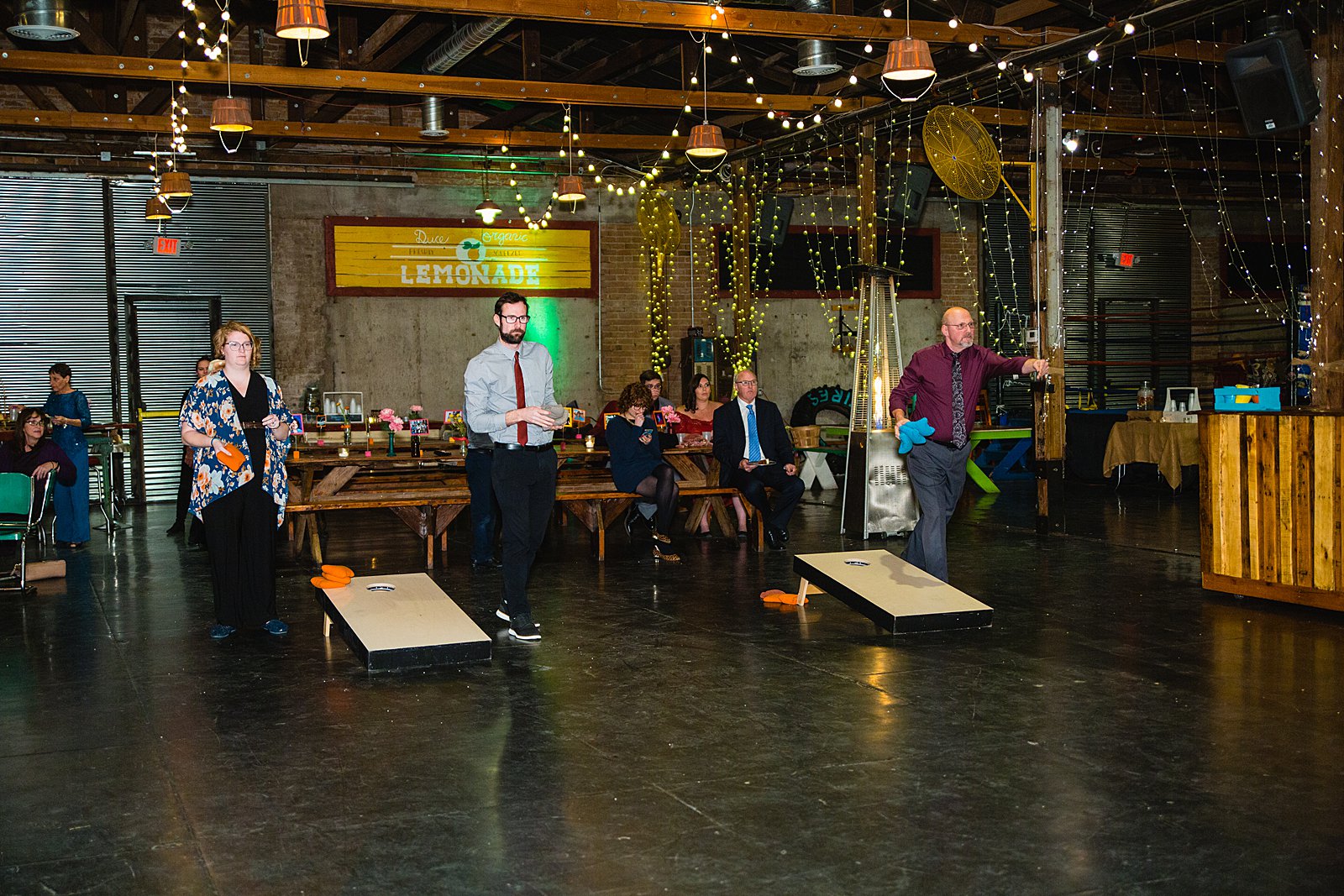 Guests playing corn hole at a low key wedding reception at The Duce by PMA Photography.