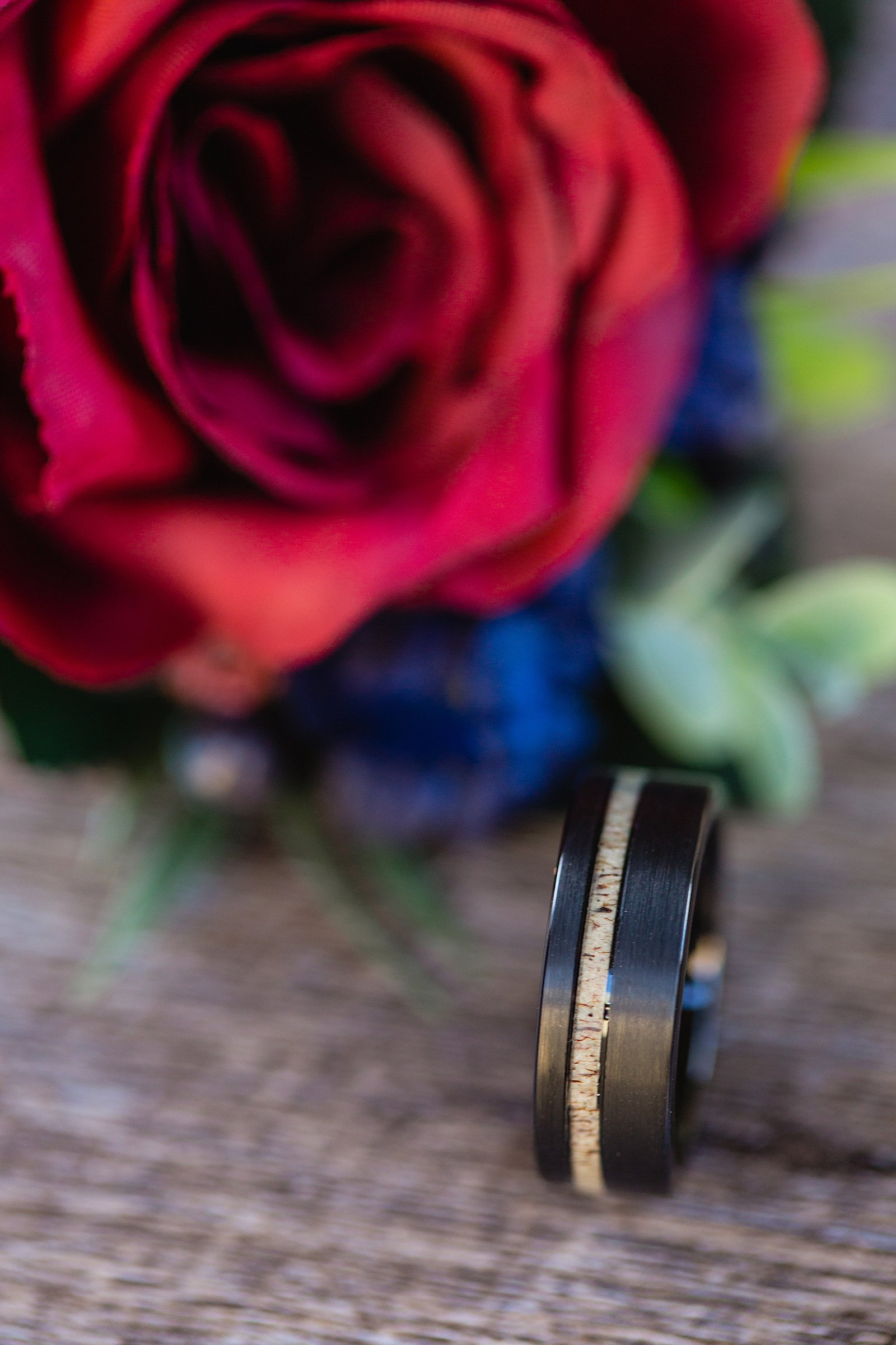 Groom's wedding day details of custom wedding ring and boutonniere by PMA Photography.