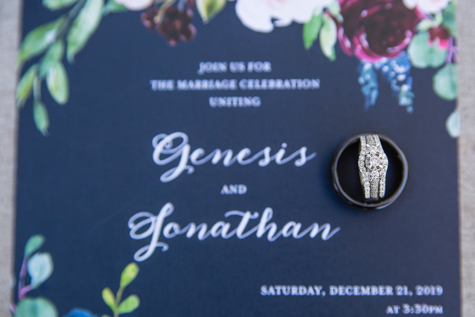 Navy garden wedding invitations with the bride and grooms wedding rings by PMA Photography.