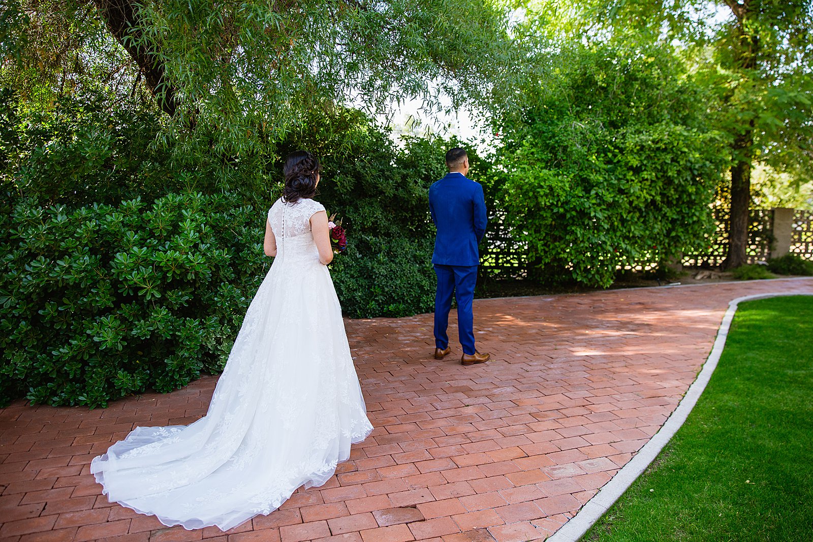Bride and Groom's first look at Valley Garden Center by Phoenix wedding photographer PMA Photography.