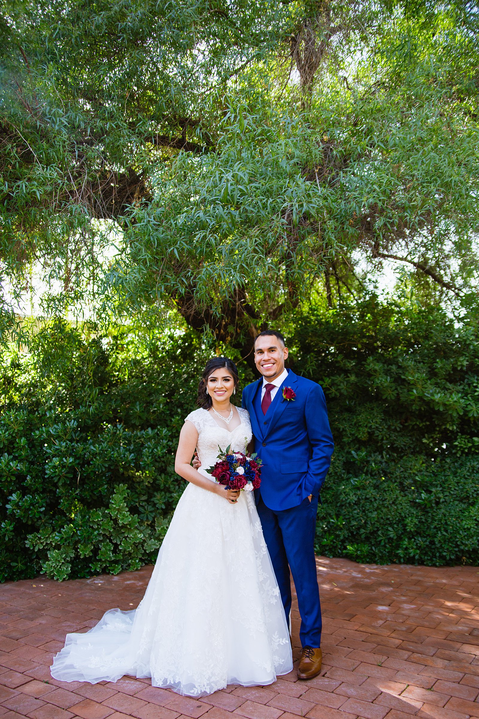 Bride and Groom pose during their Valley Garden Center wedding by Arizona wedding photographer PMA Photography.