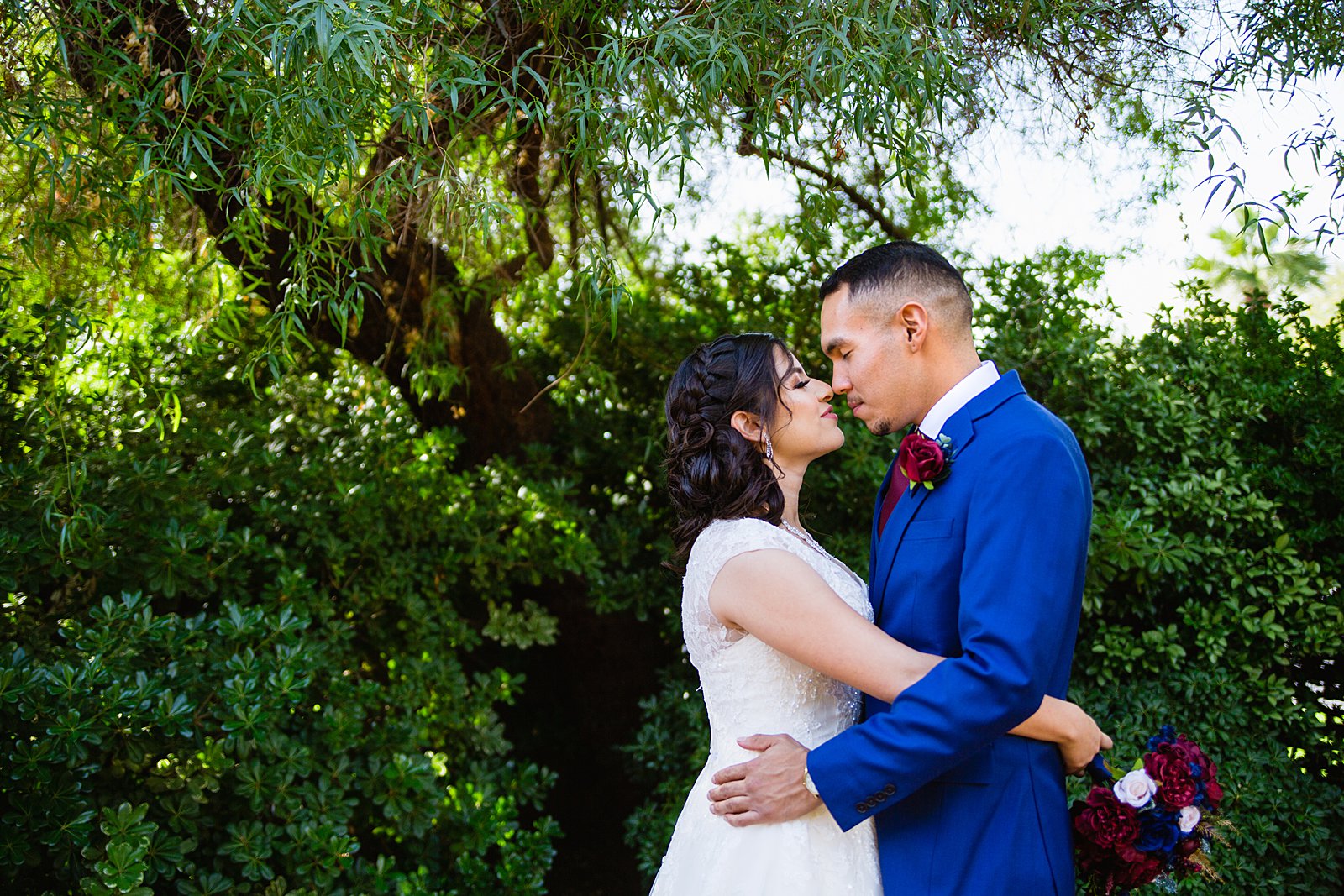 Bride and Groom share an intimate moment during their Valley Garden Center wedding by Phoenix wedding photographer PMA Photography.