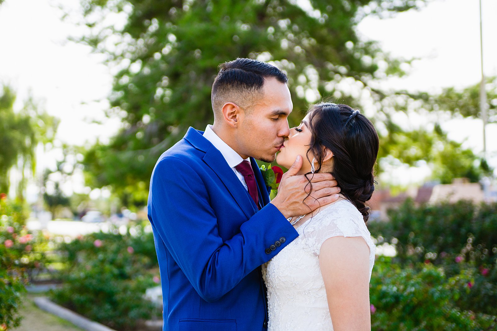Bride and Groom share a kiss during their Valley Garden Center wedding by Phoenix wedding photographer PMA Photography.