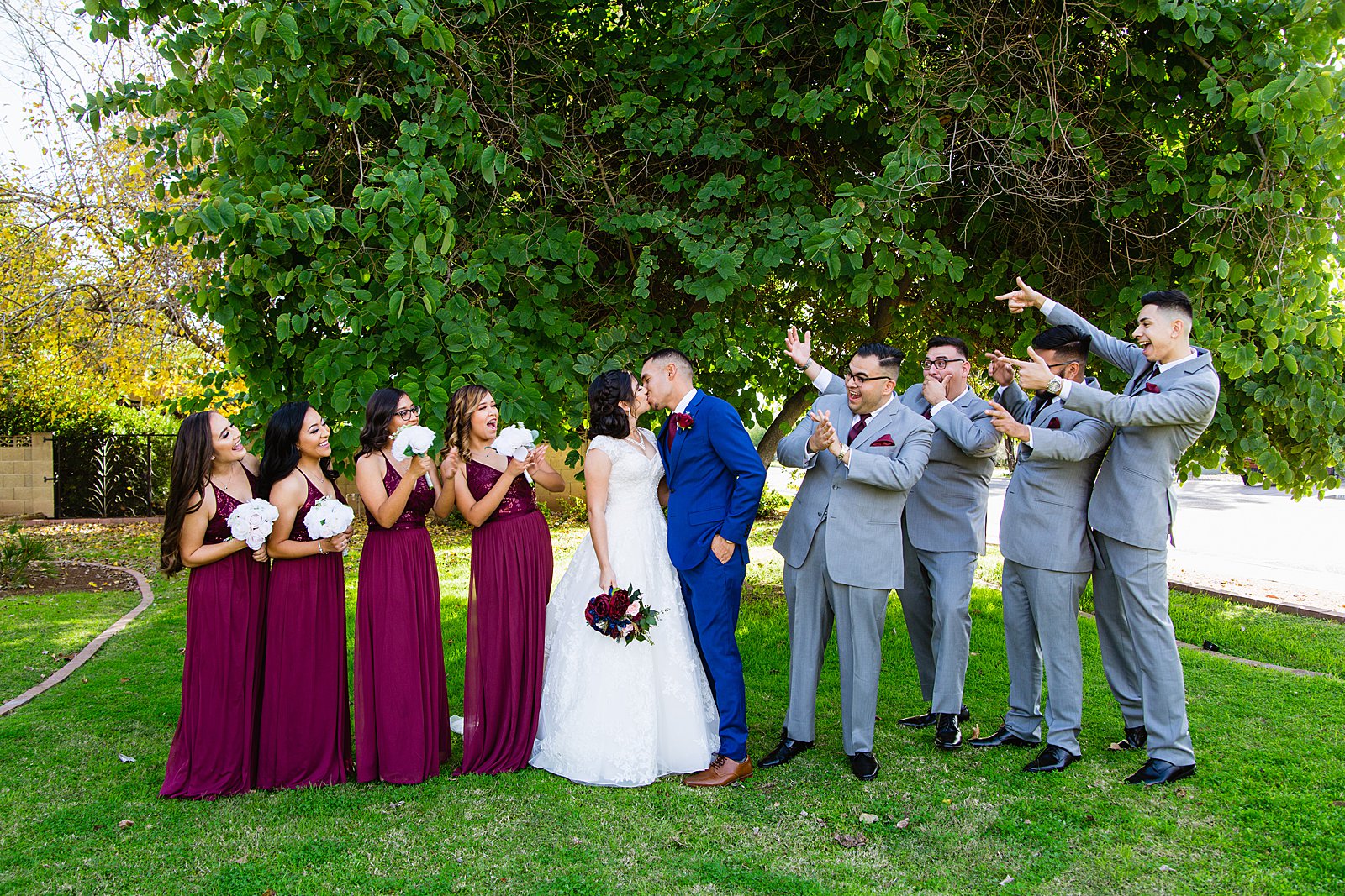 Bridal party having fun together at Valley Garden Center weding by Arizona wedding photographer PMA Photography.